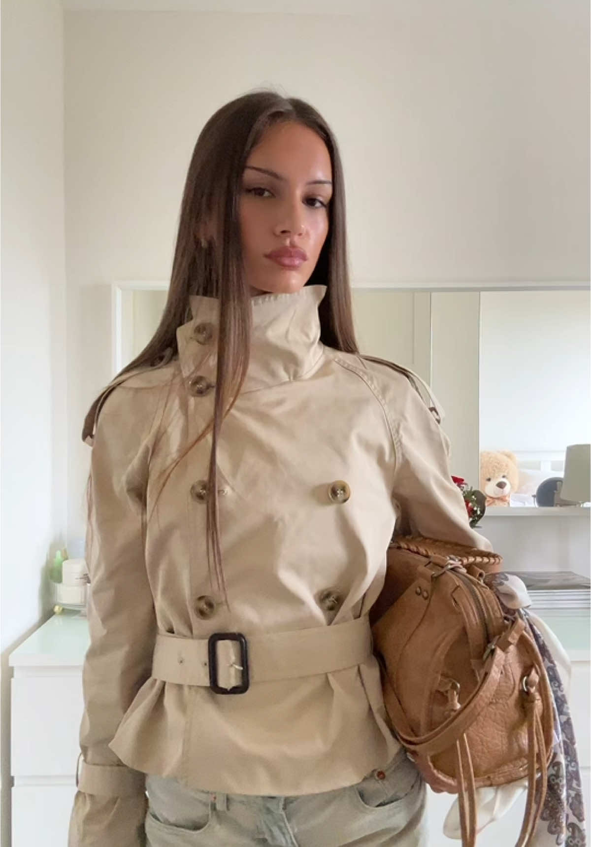 TRENCH COAT BUTTONED TO THE TOP 