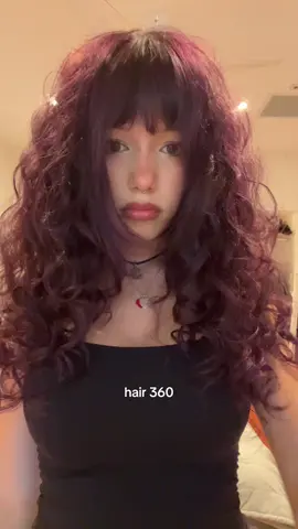 sorry it doesn’t rly show it. my hair is uneven and weird i cut it myslef also dyed it myself with manic panic purple haze and i have no hair tutorial i just have curly hair/ wavy hair and i straighten my bangs i use a bit of curl creme and gel but ya enoguh about my plz notice my funny tiktoks plz 😣😣