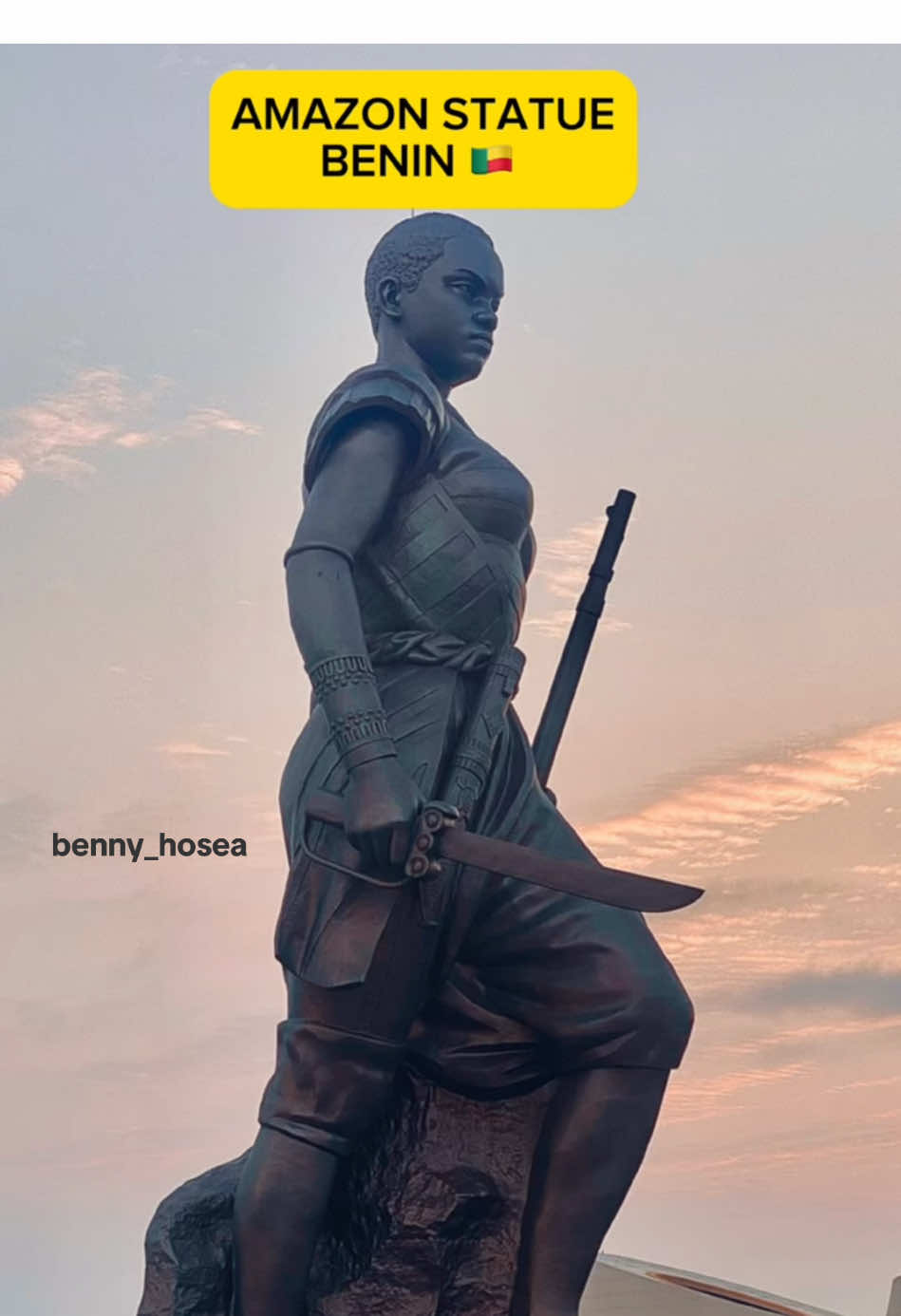 The Amazon Statue in Cotonou, Benin Republic stands 98 feet tall, honoring Queen Tassi Hangbe—the only female ruler of Dahomey and founder of the legendary Agojié warriors. This elite all-female military unit, often called the Dahomey Amazons, fiercely defended their kingdom for nearly 200 years. Would you visit this historic landmark? 🇧🇯✨ #benintitok🇧🇯 #cotonou229🇧🇯 #travelvlog #africa #tourafrica #cotonou229🇧🇯 #bennyhosea #fyp   @Creative in Lagos 