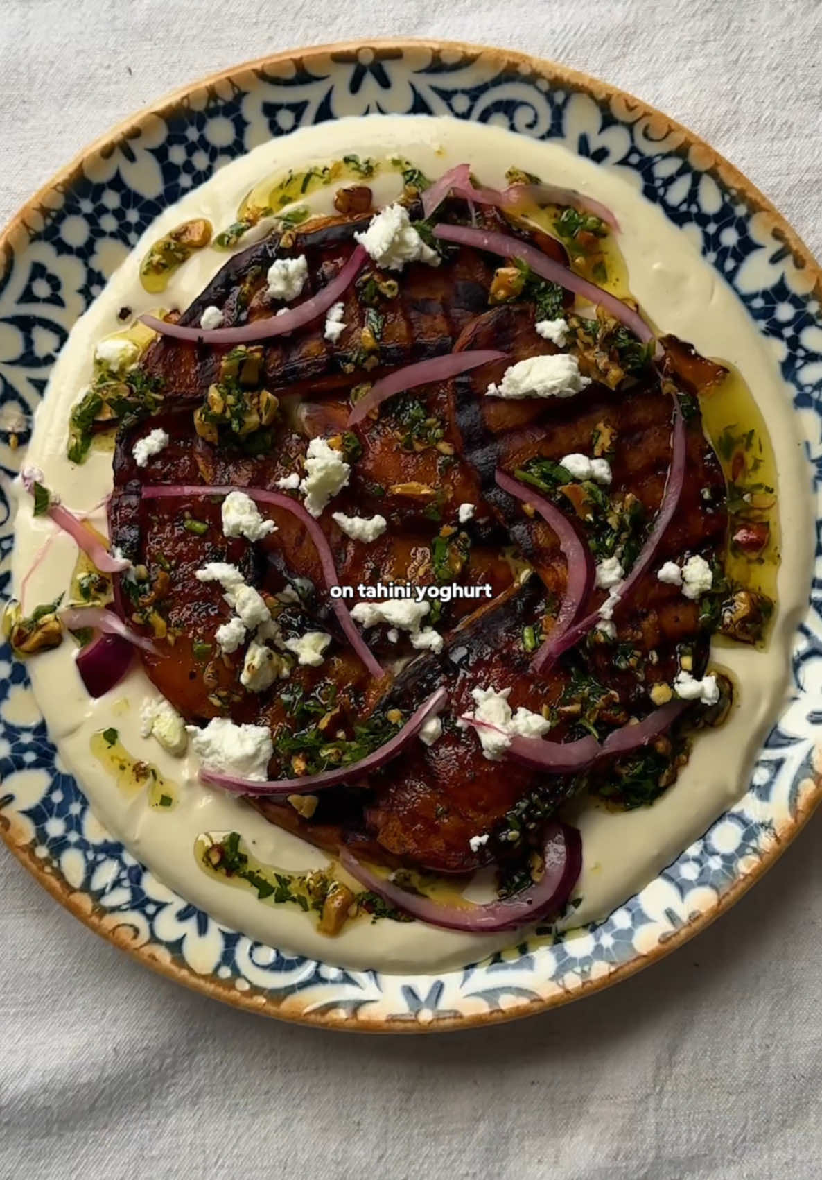 GRIDDLED SWEET POTATO, GREMOLATA + TAHINI YOGHURT 🍠 not sure about you, but I definitely don’t cook or eat enough sweet potato. and this recipe is a reminder of how delicious it can be. especially when griddled, served with a nutty gremolata, creamy tahini yoghurt, pickled onions + feta to finish. delicious 🤤  you can find my full written recipe below 👇 so enjoy! and let me know if you give it a go 😍 INGREDIENTS (serves 2) 2 small sweet potatoes 30g fresh parsley 50g toasted nuts 1 lemon, juice + zest 2 garlic cloves, minced 200g greek-style yoghurt 4 tbsp tahini Extra virgin olive oil, salt + pepper Optional extras: pickled onions + feta METHOD 1. Chop the sweet potatoes into 1-2cm thick slices. Season with salt, pepper, and olive oil. You could add smoked paprika or oregano here too.  2. Get a griddle pan nice + hot. Once smoking, add the sweet potato slices + press down with something heavy for a 3-5 minutes. Flip + repeat, so that both sides are nicely charred. In a pre-heated oven or air-fryer, finish cooking the potatoes for 5-10 minutes until tender.  3. To make the gremolata, chop up your toasted nuts + parsley. In a mixing bowl, add with 1 minced garlic clove. Stream in a good glug of olive oil + grate the zest of 1/2 a lemon. Season to taste with salt + pepper, adding some lemon juice too if you like.  4. For the tahini yoghurt, simply whisk together the yoghurt, 1 minced garlic clove, tahini + lemon juice. Season with salt.  5. To serve, spread the yoghurt out in the middle of a plate. Top with the griddled sweet potatoes, then lashings of the nutty gremolata. I crumbled on some feta + pickled onions too - then best enjoyed shared with a salad + some bread.  #sweetpotato #EasyRecipes #healthyrecipes #plantbasedrecipes 