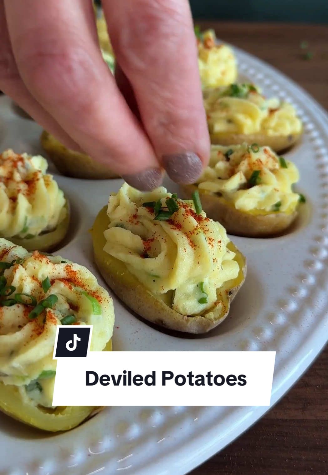 No eggs? No problem 🫡 We got you covered on the deviled egg front with these deliciously deceiving Deviled Potatoes! They're the perfect spring appetizer and budget-friendly, too. Be sure to continue reading for the recipe!  Ingredients: 1 1/2 pounds baby gold potatoes 1 tablespoon kosher salt, plus more to taste 1/2 cup mayonnaise 2 teaspoons yellow mustard 1/4 cup sweet pickle relish 1/4 cup finely chopped green onions 1/2 teaspoon freshly ground black pepper 1/2 teaspoon paprika chopped chives for garnish Directions Cover potatoes by 2 inches with water in a large saucepan. Add salt and bring potatoes to a boil over high heat. Cook until potatoes are fork tender, about 12 minutes, and drain. When potatoes are just cool enough to handle, cut each one in half lengthwise, to most resemble the shape of an egg. Use a small measuring spoon or melon baller to scoop out the center of each potato, leaving about a 1/8-inch border. Add potato flesh to a bowl.  Mash potato flesh with a fork and stir in mayonnaise, mustard, relish, green onions, and  pepper. Season with salt to taste. Spoon or pipe mixture into each potato “shell” and sprinkle with paprika. Sprinkle with chives if desired and serve immediately or refrigerate until ready to serve. 👨‍🍳: @NicoleMcLaughlin  #potatoes #deviledeggs #potatosalad #easyappetizers #easymeals #appetizers