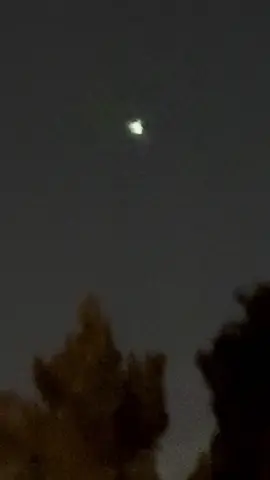 Strange orbs hovering almost nightly. Some appear to transition from an orb to a small aircraft and vice versa. You’ll notice in this shot what looks like a small aircraft low and to the right moving right to left between the trees with red blinking lights becomes a white orb slowing rising from behind the trees and below the centered orb. Vegas magic trick? Possibly but the best trick I’ve seen so far. Check it out and share your thoughts. I have more!