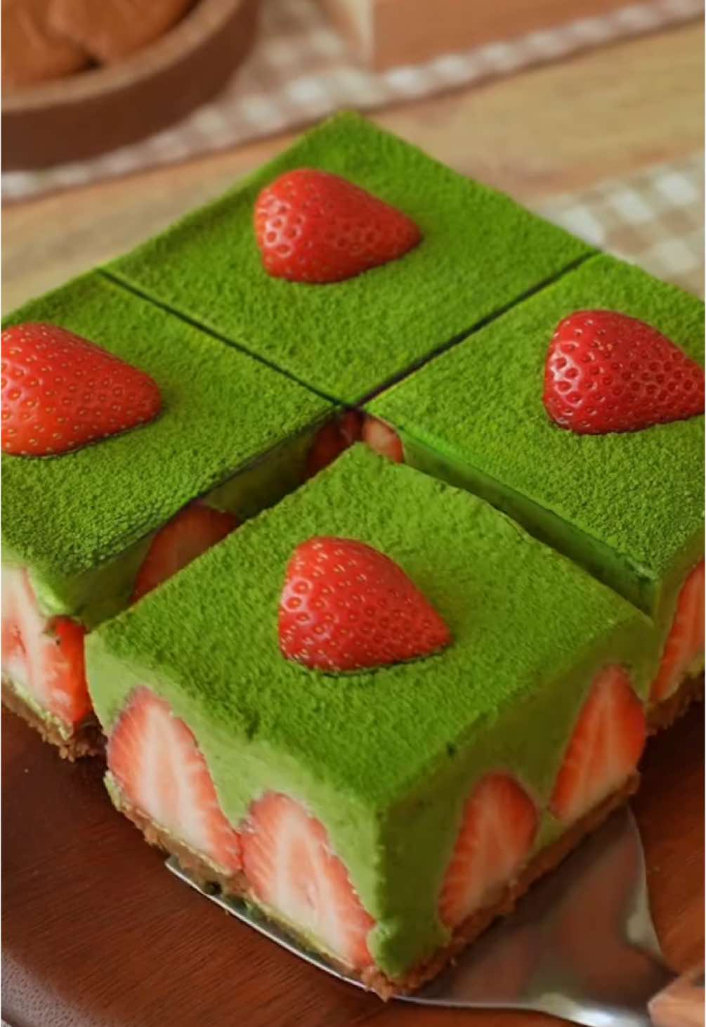 Strawberry Matcha Mousse Cake 🍓🍵🍃 No bake matcha goodness with silky white chocolate, perfectly covering fresh juicy strawberries ugh 👨🏻‍🍼 Ingredients Crust: - 150g Biscoff Lotus biscuits (or any biscuits of your choice, e.g., Oreos) - 50g melted butter Strawberry Matcha Mousse: - 250g white chocolate, chopped - 200ml heavy cream (for melting with chocolate) - 2 egg yolks - 10g gelatin (6 sheets) - 15g matcha powder, sifted - 250ml heavy cream - 17-20 fresh strawberries Topping: - Matcha powder (for dusting) - Extra strawberries for garnish Square cake pan: 15 cm/6 inches Instructions 1. Crush the Biscoff biscuits into fine crumbs. Add the melted butter and mix until evenly combined. Press the mixture firmly into the bottom of a square cake pan and smooth it out. 2. Arrange the whole strawberries standing upright along the edges and throughout the base on top of the crust. Chill in the fridge while preparing the mousse. 3. Soak the gelatin sheets in cold water for about 5-10 minutes until they become soft. Squeeze out any excess water. 4. In a saucepan, heat the white chocolate and 200ml of heavy cream until melted. Whisk in the egg yolks, gelatin, and sifted matcha powder, stirring until well combined. Let it cool down. 5. Gradually add the cooled matcha mixture to the remaining 250ml of heavy cream, mixing well until smooth. 6. Pour the matcha mousse over the strawberries, ensuring it fills all gaps. Cover and refrigerate for at least 4-6 hours, or overnight for best results. 7. Once set, carefully remove the cake from the mold. Dust the top with matcha powder and decorate with fresh strawberries. Enjoy! #matcha #strawberrymatcha #matchacake #matchamousse #matchadessert #nobake #cake