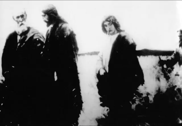 This photo was taken by an Orthodox Greek woman, Mrs Elpida, in 1998, while travelling with a group of devotees to Mount Sinai. At one point, Elpida decided to use her camera to capture (photograph) the beautiful landscape of the desert directly through the bus window. When she returned to Athens, and took the film of the device to be developed, she discovered with astonishment, that 35 shots were in color, and only one photo was in black and white. Ms. Elpida remembered that it was exactly that shot when she photographed the desert near Mount Sinai. Anyone who saw this photo would have noticed that Christ was in the center, but the identity of the other three characters in the photo remained a mystery. With the help of a friend in 2000, in one of the churches in Athens, Elpida met a spiritual person named John. She showed him a photo and told the story. John then told her: 