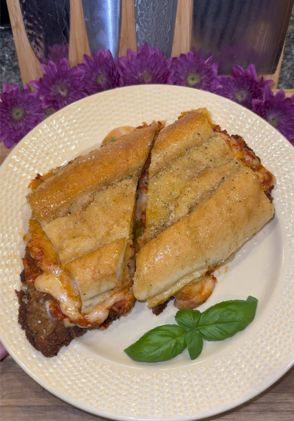 Steak Parmesan Sandwich made with Buttery Garlic Bread🥩🥖 #Recipe #sandwich #steak #FoodTok  Start out by getting some thinly sliced Top Sirloin.  Then add Flour to one plate, and in another plate add 1 part Italian Breadcrumbs and 1 part grated Parmesan.  Season both generously, (today I’m using granulated garlic and a couple of all purpose seasonings, but you can really use whatever you want.) Then dip your steak into the flour, then into some whisked eggs, and then pack on the breadcrumbs.  Fry it in about 1 inch of high heat oil (heated to about 320 degrees) until it’s golden brown, letting it rest on a cooling rack.  Then melt some butter, and season it with: -dry oregano  -granulated garlic  -grated Parmesan  -and salt & pepper  Then get your favorite sturdy sandwich bread, (I love using Cuban Bread) and cut it into the size of your steak.  Add it to a large sheet of foil, and coat the inside and outside of the bread with the garlic butter.  Then assemble your sandwich, starting with: -a layer or your favorite Marinara sauce (on the bottom piece of bread) -shredded Mozzarella cheese -your steak  -more Mozzarella  -some fresh Basil  Then coat the top piece of bread with more Marinara, and some grated Parmesan.  Wrap your sandwich tightly in the foil, and warm it in the oven at about 350 degrees for 10 to 15 minutes, or until the cheese is melted.  Enjoy💜