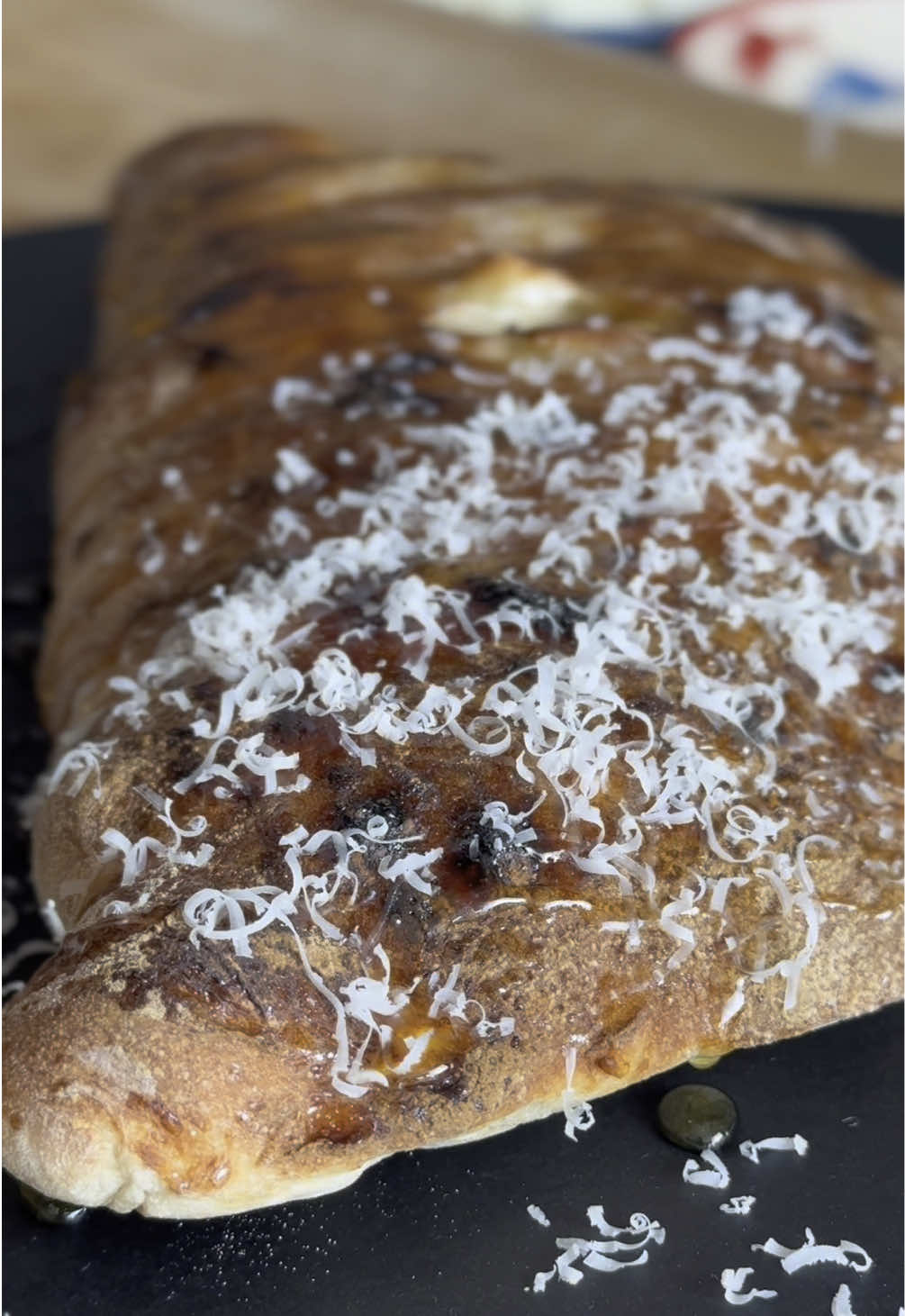 Ready for a pizza tour around Italy?? 🍕🔥 Let's star from Sardinia with an amazing Seadas Calzone! Sweet, cheesy, and irresistibly golden! 🍯🧀✨ @Daniele Uditi #giallozafferano #giallolovesityaly #PizzaLover #SweetAndSavory #ItalianFood #CheeseHeaven  

Ingredients:
For the dough (7-8 portions)
Flour 00: 8 cups (1 kg)
Water: 2 ⅓ cups + ⅓ cup (550 g + 100 g)
Salt: 2 tablespoons (35 g)
Fresh yeast: 2 ¼ teaspoons (7 g)

3.5 oz fior di latte (100g)
2.5 oz mild pecorino cheese (70g)
2 teaspoons granulated sugar (10g)
Honey (as much as you want)

Instructions for the dough:
Put the flour in a bowl and add 90% of the water.
Mix for 3-4 minutes. Don’t worry if the dough is still rough at this stage.
Let the dough rest covered for one hour.
Dissolve the yeast in the remaining water.
Add the yeast mixture to the dough, then the salt.
Mix until the dough no longer sticks to the bowl.
Let the dough rest uncovered for 5 minutes, then cover and let it rest at room temperature for 30 minutes to 1 hour.
Divide the dough into portions of 250-280 grams each.
To shape each portion, lift one end of the dough and fold it toward the center. Repeat with the other three ends.
Turn the dough over and start rounding it by moving it back and forth on the work surface until you have a smooth, even ball. Place the dough balls in a pizza dough container and cover with the lid.
Let the dough rise until it doubles in size.

Stretch the pizza dough into a 9-inch round.
Add the fior di latte and pecorino in the center.
Fold the dough over, sealing the edges tightly.
Poke a small hole in the center to let steam escape during baking.
Sprinkle sugar over the crust.
Bake at 500-550°F for 7-10 minutes, until golden brown.
Drizzle with honey while still 


 