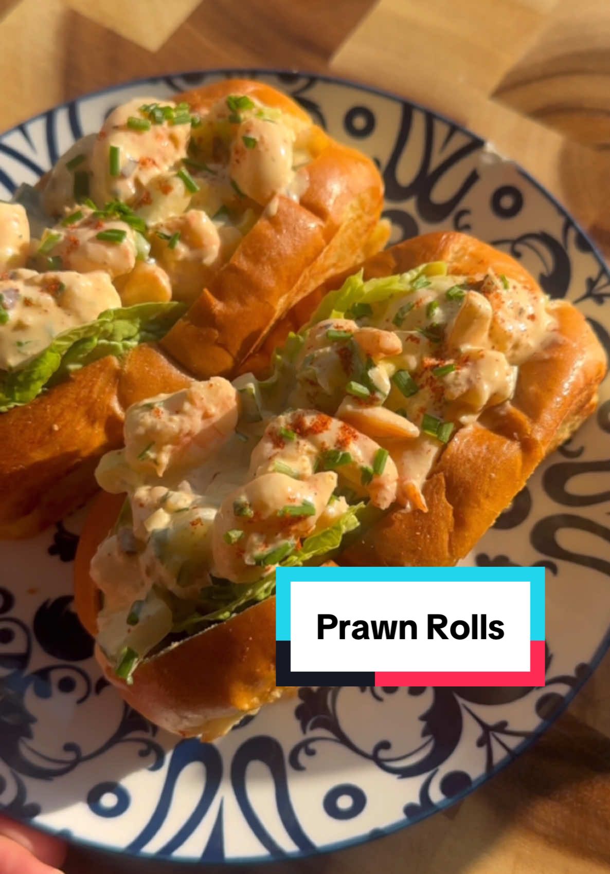 Ramadan Recipes: Prawn Rolls It’s doesn’t look as good as the Harrods one but I promise you it tastes better For the prawns: - 300g deveined king prawns - 1 tbsp butter - 2 garlic cloves - 1 tsp paprika - 1 tsp onion powder - 1/2 tsp black pepper For the filling: - Cooked & chopped king prawns - 2 spring onions, greens only - 1/2 cup diced cucumber - 2 tbsp chopped chives - 3 tbsp mayo - Salt & pepper - 1 tsp chilli oil To serve: - 4 brioche hot dog rolls - Mini gem lettuce - Chopped chives - Paprika Method: 1. Melt butter in a pan over medium heat. Once melted, add minced garlic and deveined raw king prawns. Season with your preferred spices and cook until the prawns turn pink and opaque, about 3-4 minutes. 2. Allow the prawns to cool then chop them into large chunks. 3. In a bowl, combine the chopped prawns with cucumber or celery, spring onion greens, chives, mayonnaise, chili oil and freshly cracked black pepper and salt. Mix well and set aside. 4. Trim the sides off the brioche rolls to create a flat surface. Lightly butter a pan and toast on low-medium heat until golden brown, about 1-2 minutes per side. Set aside to cool. 5. To assemble, place a small lettuce leaf in each roll, followed by 2-3 tablespoons of the prawn mixture. Top with chopped chives and a light sprinkle of paprika. Serve and enjoy! #prawn #harrods #virał #lobsterroll #ramadanrecipes 