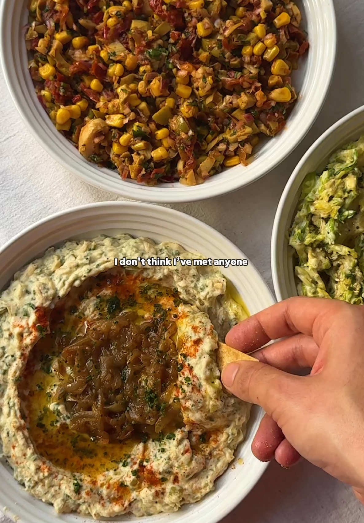 DIPS + CHIPS ❤️🤍💚 you cannot beat homemade dips + chips. they really are the perfect snack. so here are 3 dip recipes for you to enjoy making at home 👇 CARAMELISED ONION, SOUR CREAM & CHIVE DIP 🧅 SPEEDY SUNDRIED TOMATO + ARTICHOKE SALSA 🍅 CREAMY SHREDDED TAHINI SLAW 🥬 (each serves 4-6) 1. For the caramelised onion dip, slice 2 large brown onions, add to a pan with butter, oil + a pinch of salt. Cook on a low heat for 20-30 minutes (longer the better), deglazing the pan with a splash of water when it catches.  In a bowl, mix the caramelised onions with 200g sour cream / cream cheese, 1 clove of minced garlic, a handful each of finely chopped chives, + pickles. Season with salt, pepper & lemon juice. Serve with a good drizzle of olive oil, more caramelised onions, chives + smoked paprika. 2. For the salsa, finely chop up one jar each of sun-dried tomatoes, artichokes, roasted red peppers + your favourite olives. Add to a mixing bowl with a tin of sweetcorn, 1 diced red onion, a large handful of chopped parsley. Season to taste with salt, pepper + lemon juice, then finish off with a good glug of olive oil  3. For the slaw, shred 1/2 a cabbage (or sprouts like I used), then in a mixing bowl add a large pinch of salt, the juice of a lemon + a good drizzle of olive oil. Massage well with your hands to soften the cabbage + break it down. Then add a good dollop of mayo, 1 tsp dijon mustard, 1 minced garlic clove, then 1 tbsp tahini + 2 tbsp nutritional yeast if you like. Finish with lemon zest + black pepper.  4. For the homemade tortilla chips, slice your tortilla wraps into triangles, drizzle with olive oil, season with salt + pepper, then mix well to coat. Air fry or bake for around 10 minutes at 180 degrees celsius, or until crisp. Mix through your preferred seasoning. (all dips were made with plant-based alternatives) #dips #chips #EasyRecipes #plantbasedfood #comfortfood 