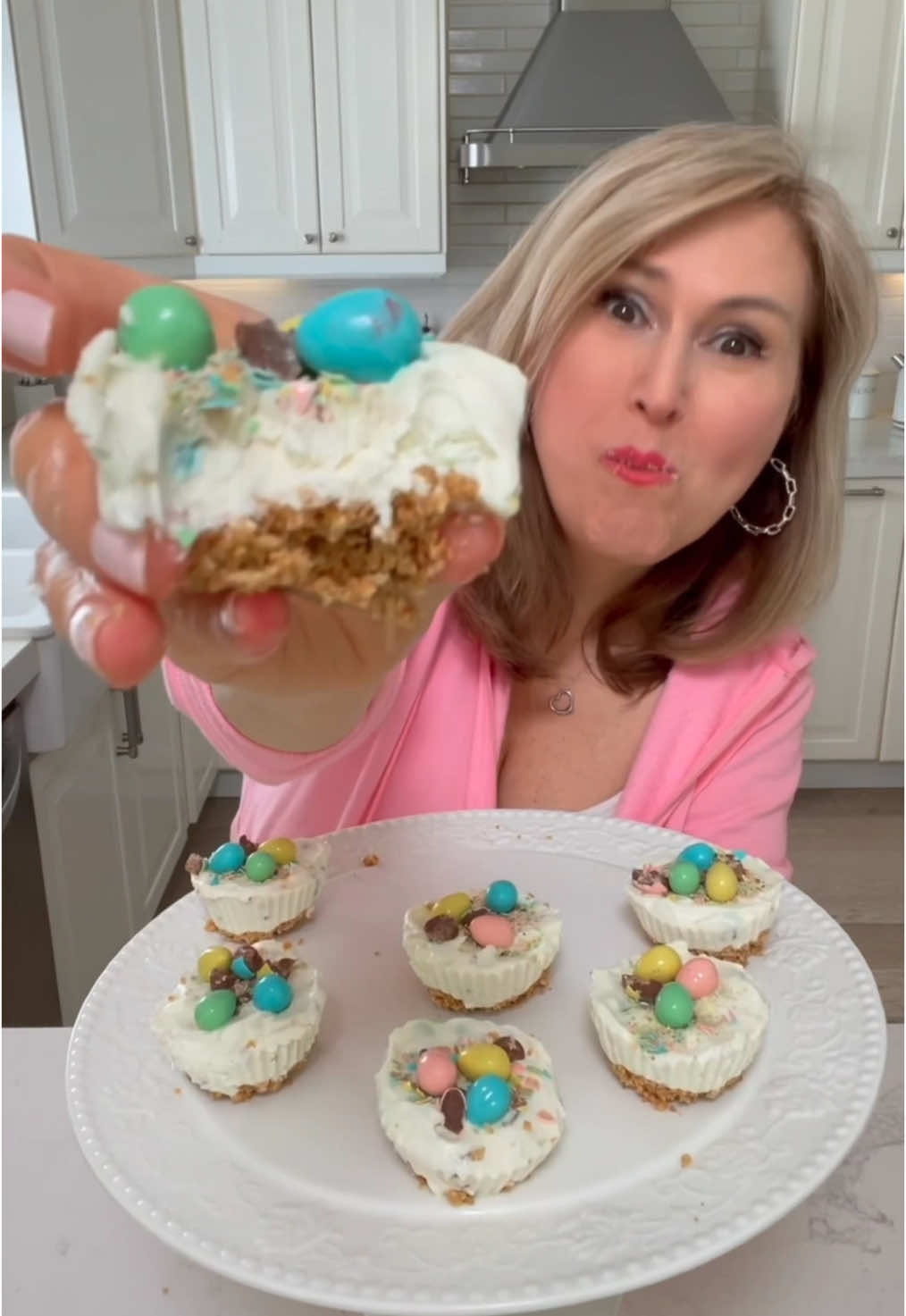 Easy No Bake Cheesecakes  1 cup Graham cracker crumbs  1/4 cup salted butter  (I also add 1tbsp or 2 dark brown sugar)  Pat down into your silicone baking cups and place in fridge while you make the filling.  Filling 1/2 cup whipping cream (heavy cream) 8 ounces cream cheese 1/3 cup powdered sugar 1 tosp sour cream squeeze of lemon (1tsp) 1 tsp vanilla extract 3/4 cup crushed Mini Easter Eggs (save some of the pieces for the topping) Let me know if you make them!! #easter #EasyRecipe #dessert #minicheesecake