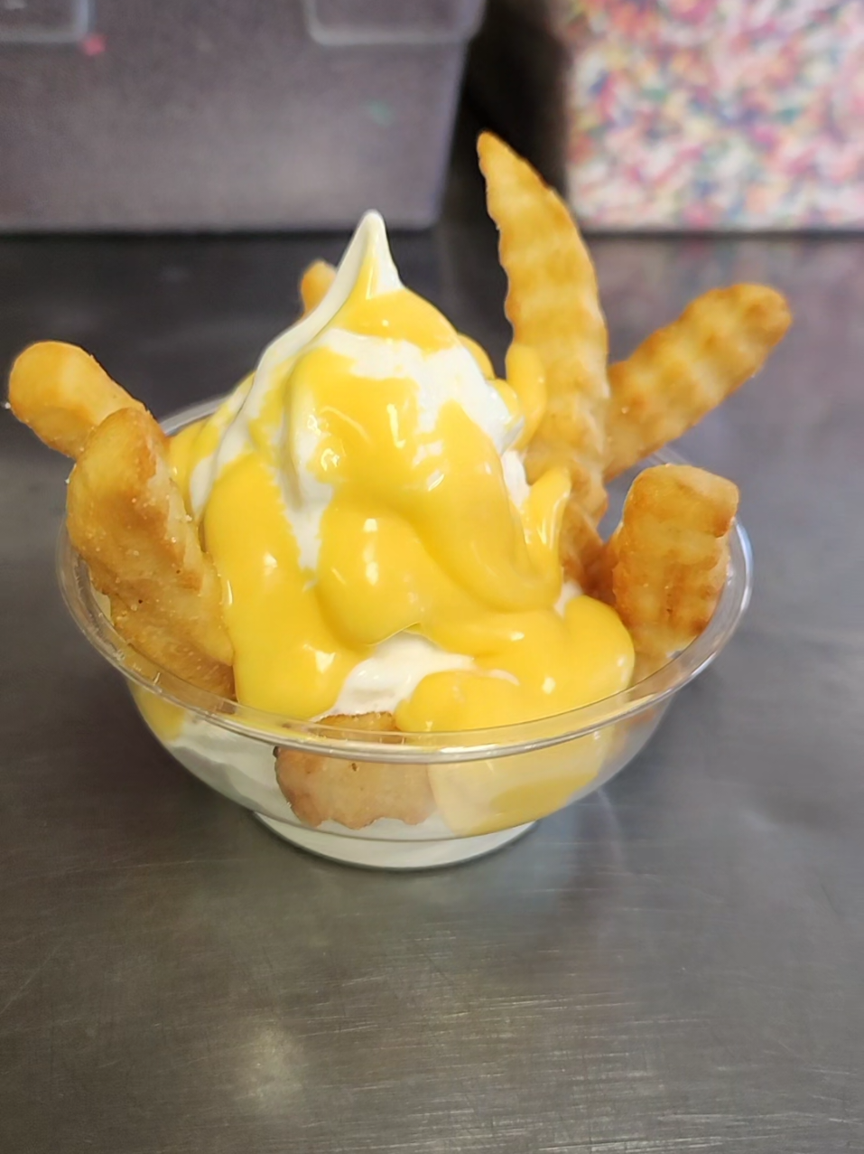 Try our new sundae, vanilla ice cream with French fries and nacho cheese. #yum #joesdairybarandgrill #joesdairybar #icecream #softserve #vanilla #softserveicecream #nachocheese #fries #sprinkles 