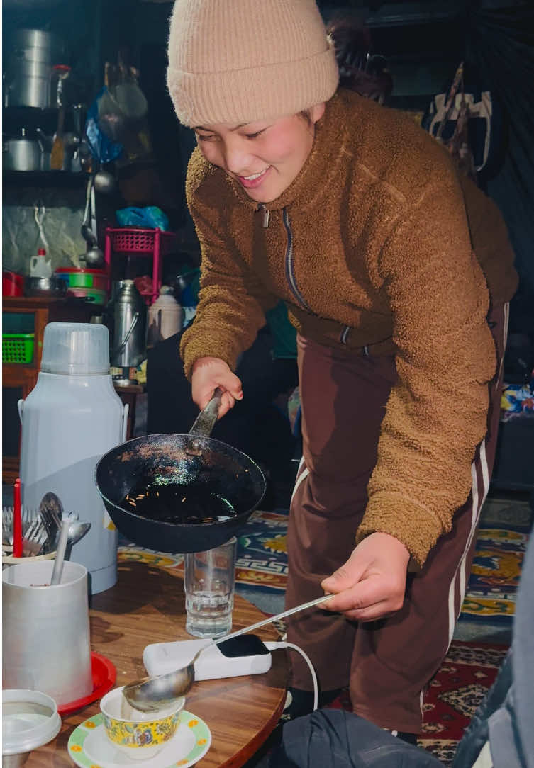 JHUWAI KATTE is a traditional drink made by roasting raw rice seeds in yak's ghee, then adding local alcohol after the flame is turned off. After resting for a few minutes, it's boiled to create a warming beverage perfect for combating cold. This drink not only warms the body but also offers a comforting experience, making it a favorite during travels to cold places. On my journey to Bhairav Kunda, I had the pleasure of staying at Aama Xomen Homestay, located in Bagam, a key trekking point. You can easily find it by looking for a large sign at the entrance of Bagam that indicates Aama Xomen Restaurant and Lodge. This homestay offers an immersive experience into Sherpa culture, complete with delicious local cuisine and warm hospitality. For inquiries, you can contact them at 9741400660 or 9869757095. I highly recommend Aama Xomen for those seeking new experiences and a cozy retreat. Our two nights there were truly unforgettable!  #bhairavkunda #bakuray #visitnepal #explorenepal #visitnepal2025 #fyp #nepal #mountains #sherpa #culture #sherpafood