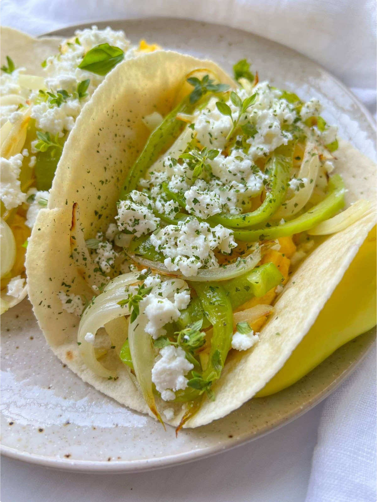 INDULGE in these QUICK, EASY, and DELICIOUS #BreakfastTacos 🌮 filled with sautéed veggies 🥗, soft eggs 🥚, and tangy feta cheese 🧀, all wrapped in a tortilla. Perfect for a morning boost! ☀️  #tacorecipes #healthybreakfastrecipes https://themodernnonna.com/breakfast-taco/