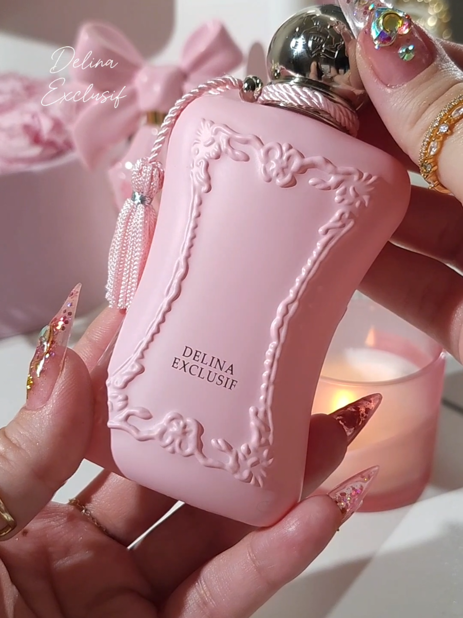 Delina Exclusif by @Parfums de Marly is the most Romantic fragrance.  She is everything they say and more. An absolutely stunning, creamy rose scent that had me hooked from the first spritz. 🌹💖 The opening is the most pleasant and elegant aroma of Damascena rose and lychee, paired with a luscious, almost candied **pear** 🍐. As it settles, the blend of vanilla, musk, and incense creates the most dreamy and romatic creamy rose aroma, with the incense and vetiver adding just the right touch of depth and allure.  But my favorite part? The dry-down! On my skin, it transforms into the most delicious rosy marshmallow scent, and I can’t get enough. 😍🍬  What are your thoughts on this fragrance? 🥰 ✔️ Use code: SCB35 FOR 35% OFF your purchase at Fragrancenet.com @Parfums de Marly  #parfumsdemarly #delinaexclusif #delina #nichefragrance #fragrancetiktok #fragrancetok #perfumetiktok #perfumetok  #fragrancelayering #fragrancecommunity #perfume #makeup #glam #girlythings #scentcombo #sotd #SelfCare #nichefragrance #nichefragrances  Perfume unboxing, fragrance unboxing, fragrance collection, perfume reviews, perfume collection, niche Fragrances, rose perfumes, scent of the day, pink Wednesday,  girly things,  Parfums De Marly,  Parfums De Marly Delina Exclusif perfume, fragrance, fragrances, fragrance community