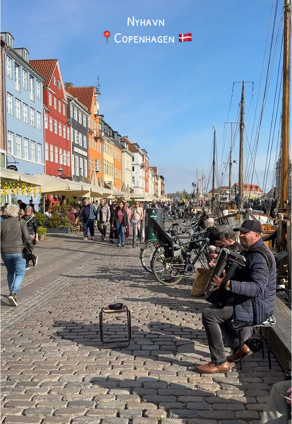 Strolling through Nyhavn, where colorful buildings meet the peaceful waters, creating the perfect Copenhagen vibe 🇩🇰#denmark🇩🇰 #fyp #foryourepage #danish #scandinavia #denmark #copenhagenstyle #happiness #copenhagen #visitcopenhagen #copenhagenvibes #city #spring #goodvibes #artist 