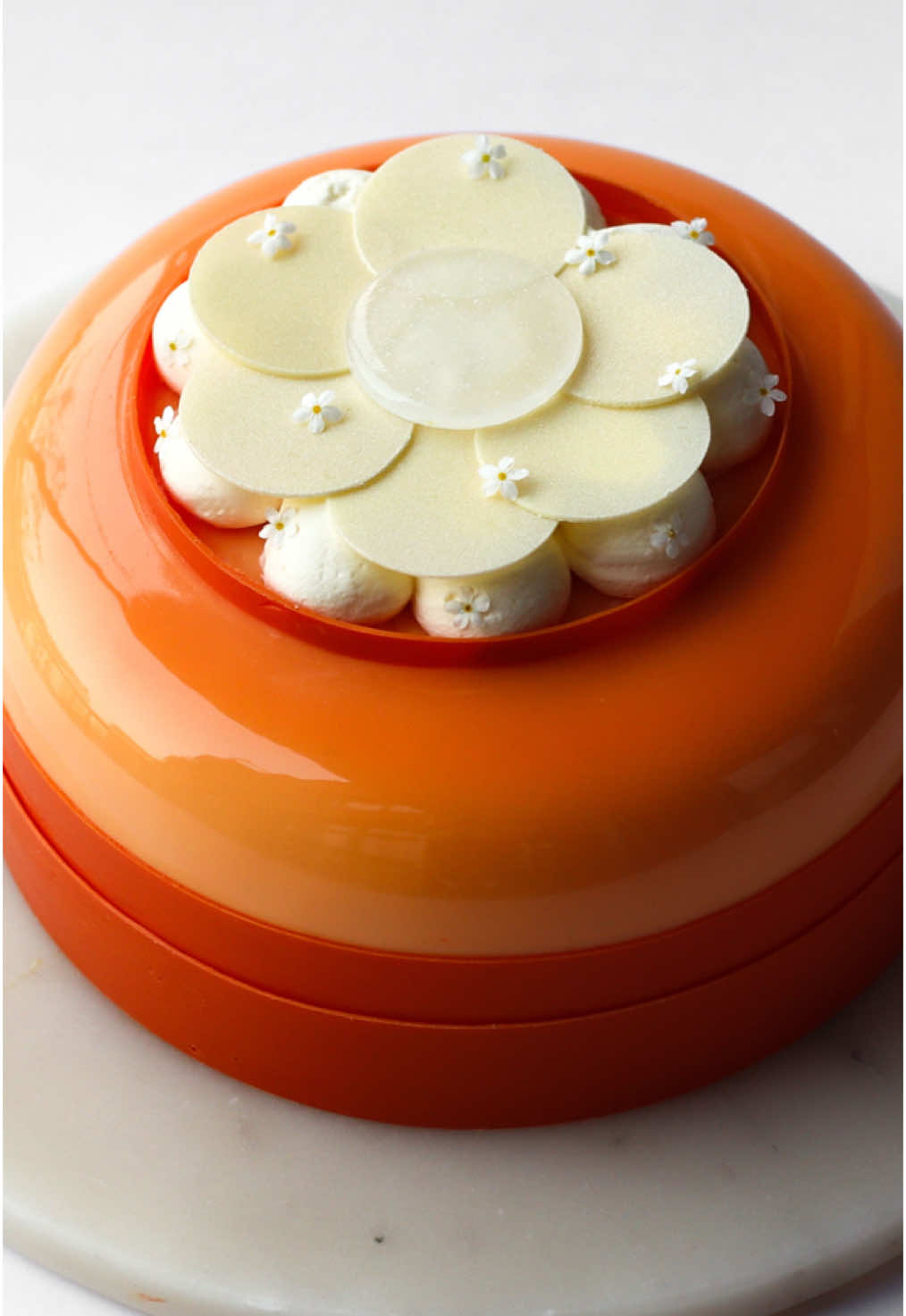 Carrot Cake with Cream Cheese & Brown Butter 🧡 “From Classic to Iconic” Baking Series - Episode 5!  If you’re looking for a next level Carrot Cake perfect for Easter, then save this post and watch my step-by-step YouTube guide via link in bio ☺️  Welcome to another episode of my Baking Series: “From Classic to Iconic” where I show you how to turn timeless, classic desserts into  modern entremet cakes ✨ In this episode, I’ve recreated the classic Carrot Cake! Because what is more suited for Easter than an elegant Carrot cake? 😍 Many of you wished for this traditional cake to be a part of the series, so here’s my take on an elevated Carrot Cake 🥕 Besides the main flavours being carrot cake and of course cream cheese, my version also contains brown butter and walnuts flavors, it has more textures with praline and broken gel, and it’s wrapped in a cute cake design!  This recipe is truly amazing and I can’t say enough how good it actually tastes!!  So if you love the classic carrot cake, I think you’ll be surprised how it can taste even better with more flavors and textures 😍 The cake consists of:  - Walnut Crunch - Carrot Cake - Brown Butter Whipped Ganache - Carrot Broken Gel - French Cream Cheese Buttercream - Walnut Praliné - Cream Cheese Mousse - Mirror Glaze - White Chocolate Whipped Ganache - Chocolate Decoration  Find the full recipe on my website via link in bio 🧡   What classic cake should I reinvent next time? 😀 #entremet #carrotcake #easter #eastercake #pastrychef #cakedecorating #cakedesign #pastry #cakeart #patisserie #cakeinspiration #mirrorglaze