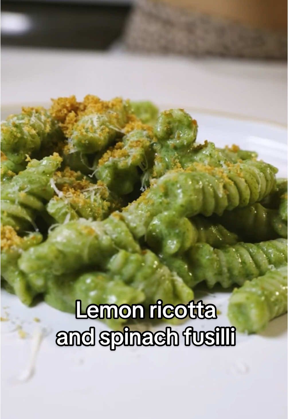 30 minute Lemon Ricotta & Spinach Fusilli Serves: 2–4 Time: ~30 minutes 12 oz fusilli pasta 1.5 cup ricotta ½ cup grated Parmesan (plus more for topping) 1 lemon (zest and juice) 2.5 cups fresh spinach 4 garlic cloves, minced 3 fresh sage leaves  ½ cup vegetable broth Olive oil (for sautéing and breadcrumbs) Salt & pepper, to taste Toasted Breadcrumb Topping ½ cup breadcrumbs Drizzle of olive oil Boil fusilli in salted water until al dente. Reserve about 1 cup of pasta water before draining. In a small pan, heat a drizzle of olive oil over medium heat. Add breadcrumbs and toast until golden brown.  In a pan, heat olive oil. Add minced garlic and sage. Sauté for 30 seconds, then add spinach. Cook until wilted. 2-3 minutes. Season with salt and pepper. Using an immersion blender, blend sautéed spinach, ricotta, Parmesan, vegetable broth, lemon juice, salt, pepper, and lemon zest.  Blend until smooth and creamy. Add a little pasta water if needed to loosen the sauce. Add the sauce to the pan. Simmer for 5 minutes to combine all the flavors. Turn off the heat. Add pasta to the sauce. Toss to coat, adding reserved pasta water a bit at a time until it reaches your desired consistency.  Top  with toasted breadcrumbs, lemon zest, a drizzle of olive oil, and extra grated Parmesan.  #lemonricottapasta #pasta #ricottapasta #lemonpasta #spinachpasta #recipes 