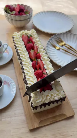 20 MINUTES CHOCOLATE CAKE (NO BAKE) #food #recipe #chocolate #pie #cake #nobake #tasty #cream #quick #fy #fyp #foryoupage   CAKE 8 chocolate cakes (store-bought) CREAM 250 g mascarpone 50 g powdered sugar 8 g vanilla sugar (1 packet) 16 g whipped cream stabilizer (2 tbsp) 400 ml heavy cream GANACHE 40 ml heavy cream 40 g dark chocolate TOPPING strawberries Place the mascarpone, powdered sugar, vanilla sugar, and whipped cream stabilizer in a deep bowl. Mix until smooth. Gradually add the heavy cream and mix until stiff. Transfer the cream into a piping bag. Remove the chocolate cupcakes from their packaging. Pipe a thin layer of cream onto a serving tray. Take one chocolate cake, spread a layer of cream on top and put it on the layer of cream. Repeat this for the rest and place the cakes next to each other in a straight row. Pipe a layer of cream over the cakes and smooth it out evenly. Heat 40 ml of heavy cream in a small saucepan until just below boiling. Remove from heat and add the chopped dark chocolate. Let it sit for 1 minute. Stir until smooth and glossy. Transfer the ganache into a piping bag. Pipe the ganache along the sides of the cake stack to create a drip effect. Pipe decorative dollops of cream along the top edges. Pour the remaining ganache in the center. Garnish with fresh strawberry pieces.