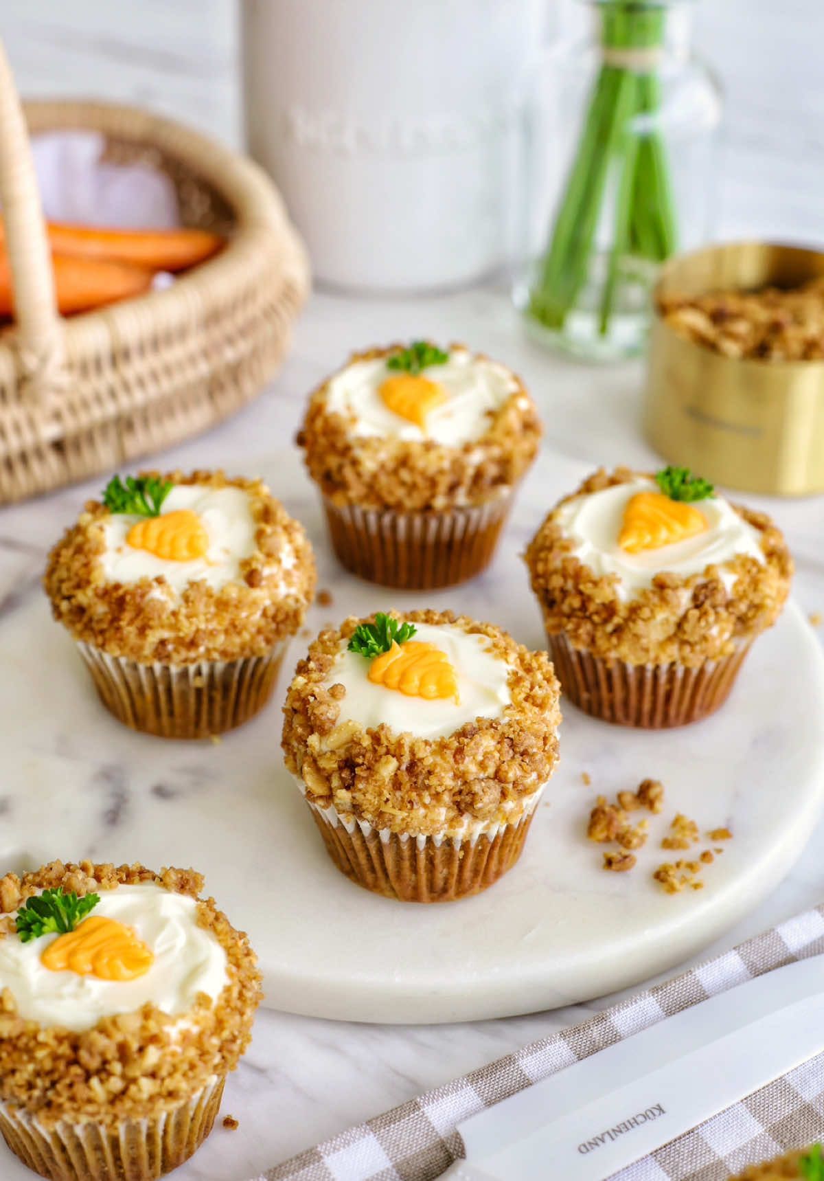 The recipe you need to make this Easter 🐣 One-Bowl Carrot 🥕Cake Muffins Recipe: •1 1/2 (180g) cup flour •2 tsp baking powder •1/2 tsp baking soda •1/2 tsp salt •1/2 tbsp cinnamon •1/4 tsp ground nutmeg •1/2 cup (120g) vegetable oil (I used rapeseed oil) •3/4 cup (150g) brown sugar •2 eggs •1/2 cup (120g) greek yogurt •1/4 cup (50g) pineapple, mashed  •2 eggs, at room temperature •1 tsp vanilla •1 cup (110g) finely grated carrots •1/2 cup (50g) pecans or any nuts, chopped Cream Cheese Frosting •1 cup (226g) cream cheese •¼ cup (50g) powdered sugar •1½ cup (360g) whipping cream Walnut Crumbles •½ cup 60g walnuts, chopped •¼ cup (50g) brown sugar •2 tbsp (20g) desiccated coconut •½ cup (60g) all-purpose flour •¼ tsp salt •¼ cup (60g) unsalted butter Method: 1.Peel and shred carrots. Roughly chop pecans. 2.Preheat oven to 350°F (175°C). 3.In a large bowl, whisk together eggs, brown sugar, oil, yoghurt, vanilla extract and pineapple until combined. 4.In another bowl, mix flour, baking powder, baking soda, salt, nutmeg and cinnamon. 5.Combine half of the dry ingredients with the wet mixture. Add carrots , then remaining dry ingredients. Stir until just combined. Fold in pecans. 6.Fill cupcake liners 3/4 full. Bake for 18-20 mins until a toothpick comes out clean. Cool completely. 7.Reduce oven to 320°F (162°C). For walnut crumble, pulse walnuts, flour, brown sugar, desiccated coconut and salt in food processor. 8.Add butter, pulse until sandy. Bake on a sheet until golden, stirring halfway. Cool. 9.For frosting, beat cream cheese, powdered sugar, vanilla, salt until smooth. Add heavy cream, beat until stiff peaks. 10.Frost cupcakes, create a flat surface in the middle. Coat sides with cooled crumble. Mix leftover frosting with orange food coloring, pipe carrot designs. Add parsley for stems. #easter 