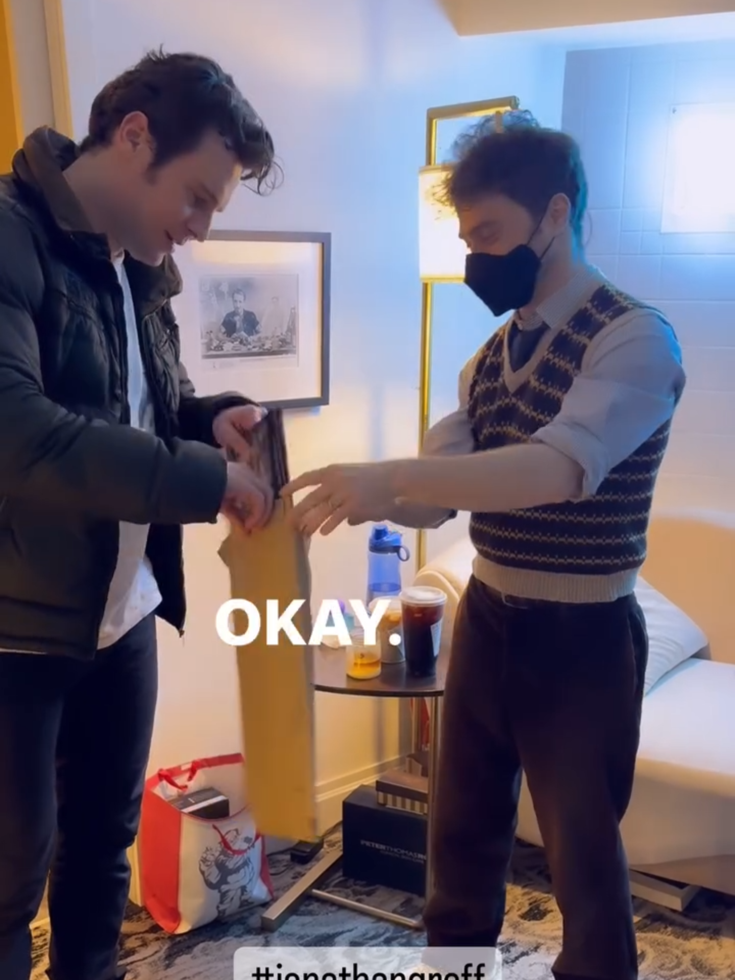 jonathan and daniel radcliffe opening the vinyl album of 