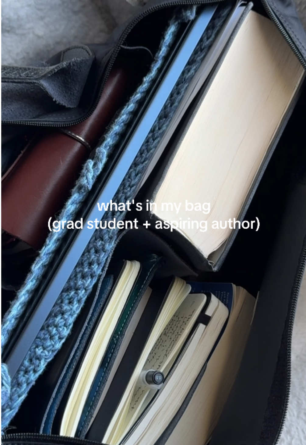 my shoulder hurts from carrying all of this lol🤣 but here is a little what's in my bag showing what I always carry around with me as someone attending grad school and also someone who is working towards their debut novel (a spec fic detective mystery novel🤭)  I have a lot of journals in there (my 2 louise carmen notebooks and my moleskine), books (legendborn, my renaissance drama anthology🥲, and tenth of december for my creative writing class), laptop (mac), my essay on the malcontent (since I had my presentation on it yesterday), and a loooot of self care products (lippies, hand cream, sanitizer, and ofc aquaphor🤌🏼) what's in your bag?  . #writing #writer #writertok #writersoftiktok #BookTok #whatsinmybag #bookish #journaling #journal #journalwithme #louisecarmen #writingabook #books #bookrecs #literature #littok #bookworm #moleskine #leuchtturm #gradschool #rhode #loccitane #laneige #aquaphor #legendborn #tracydeonn 