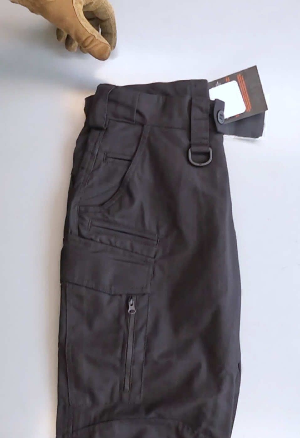Tactical Pants Lite UATAC | Black The Lite UATAC tactical pants are designed specifically for the military, have a versatile cut and are suitable for a variety of conditions of use - training, shooting range, work or walking. The fabric consists of 65% cotton and 35% polyester, which makes it pleasant to the touch and resistant to tearing and damage. Ripstop weaving will prevent the pants from tearing even under heavy loads. Large cargo pockets with Velcro.Equipped with an additional compartment for storing oversized items and a carabiner. On the side of the cargo pocket there is a zipper for convenient access while sitting. Special convenient phone pocket on the right side. Two front pockets for a knife or flashlight. Large compartment in the knee area with the possibility of installing a knee pad inside (sold separately). The belt is made elastic, with the possibility of stretching. Pants are designed to be worn with a belt up to 6 cm.Convenient Velcro fasteners on the cuffs of the pants. Fabric 65% cotton, 35% polyester. Ripstop weaving Elastic 