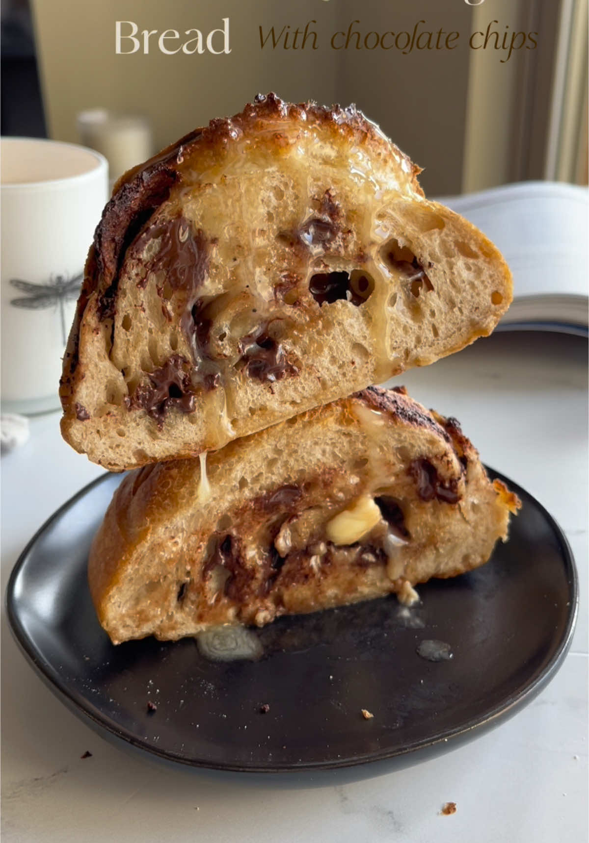 wow with this trend of croissnat sourdough bread!!! it is delicious and has a softer texture  Ingredients - 430 g white bread flour - 85 g whole wheat flour - 395 ml water (reserve 15 milliliters and combine with the salt) - 12 g salt - 110 g sourdough starter - Filling - 1 stick of butter between the 3 mini dough balls -chocolate chips (optional) Steps 1. Combine the water, flour, and sourdough starter and let it rest for 1 hour. 2. Add the salt with the remaining water and fold the dough 4 to 6 times (check the dough's measurement and Mark where the dough is) 3. Let the dough rest for 35 minutes. 4. Fold the dough 4 to 6 times and let it rest for 35 minutes. 5. Repeat step (4.) 3 more times. 6. Once you have finished folding and resting the dough, place the dough in a covered container at room temperature, until it doubles in size (compared to the mark you made in step 2.) 7. On an unfloured counter, place the dough and divide it into 3, fill each one with a little grated butter and form 3 balls, just as I show in the video (rolling and folding until a ball forms). 8. In baskets or small bowl, let the loaf rest overnight (well covered). 9. The next morning, preheat the oven to 480°F. 10. Remove the 3 balls of dough from the refrigerator and score them. 11. In your bread pan, bake the loaves with the lid closed for 15 minutes, then bake them for another 15 minutes without the lid. 12. Let the loaves cool and enjoy! #sourdough #sourdoughbread #croissantsourdough #viral #fyp #bakingtiktok #butter #creatorsearchinsights #CapCut 