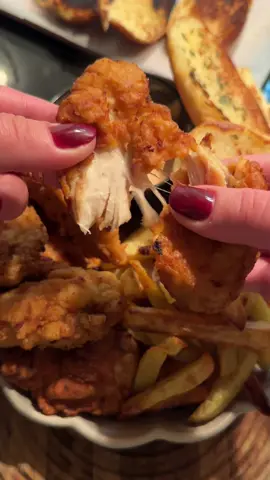 Raising Cane’s fakeaway🍟🍗 Easy homemade fast food at home🍔 🍗Chicken tenders: •chicken fillet cut into stripes🍗 •milk or buttermilk🥛 •salt, black pepper, garlic powder, smoked paprika🧂  for coating: •flour🍞 •cornstarch🥄 •salt, black pepper, garlic powder, smoked paprika🧂 •sunflower oil for frying🌻 ⬇️  1.Cut chicken into stripes. Mix milk or buttermilk with black pepper, salt, smoked paprika and garlic powder. Marinate chicken in the mixture(the more the better) (or at least for 20 mins) 2.Meanwhile, mix flour with cornstarch, salt, black pepper, garlic powder and paprika.  3.Heat some sunflower oil in a pan on a medium heat. !We don’t need to make it too much boiling not to let the chicken burn BUT hot enough to create a crispy crust! 4.You may check the readiness of oil by putting a tiny piece of flour into the pan.  5.Coat the chicken in flour mixture - then milk-buttermilk - then flour mixture again.  6.Carefully add chicken pieces into the pan. Turn them over to let them cook on each side. Control the temperature - reduce the heat a bit if needed. Cook until golden brown.  🍯Sauce: •mayo🍦 •ketchup🥫 •Worcestershire sauce🥄 •black pepper🧂 •salt(to taste)🧂 🍟Fries: 1.Cut potatoes into slices.  2.Rinse the potatoes in cold water and dry with paper towel.  3.Place the potatoes on a baking tray and mix it carefully with vegetable oil.  4.Bake in a preheated 200-210 oven with a convection mode on.  🥯Garlic buns 1.Mix vegetable oil or butter with some grated garlic, salt, *greens(optional).  2.Place on a preheated pan and fry for a couple of minutes until ready.  #raisingcanes #raisingcaneschickenfingers #raisingcanesmukbang #raisingcanesrecipe #raisingcanesathome #fastfoodathome #fakeaway #fakeawayrecipe #chickentenders #kfcathome #chickennuggets #chickenlegpiece #frenchfries #garlicbread #easydinner #dinner #moviesnack #moviesnacks #DinnerIdeas #FoodTok #cooking #cookwithme 