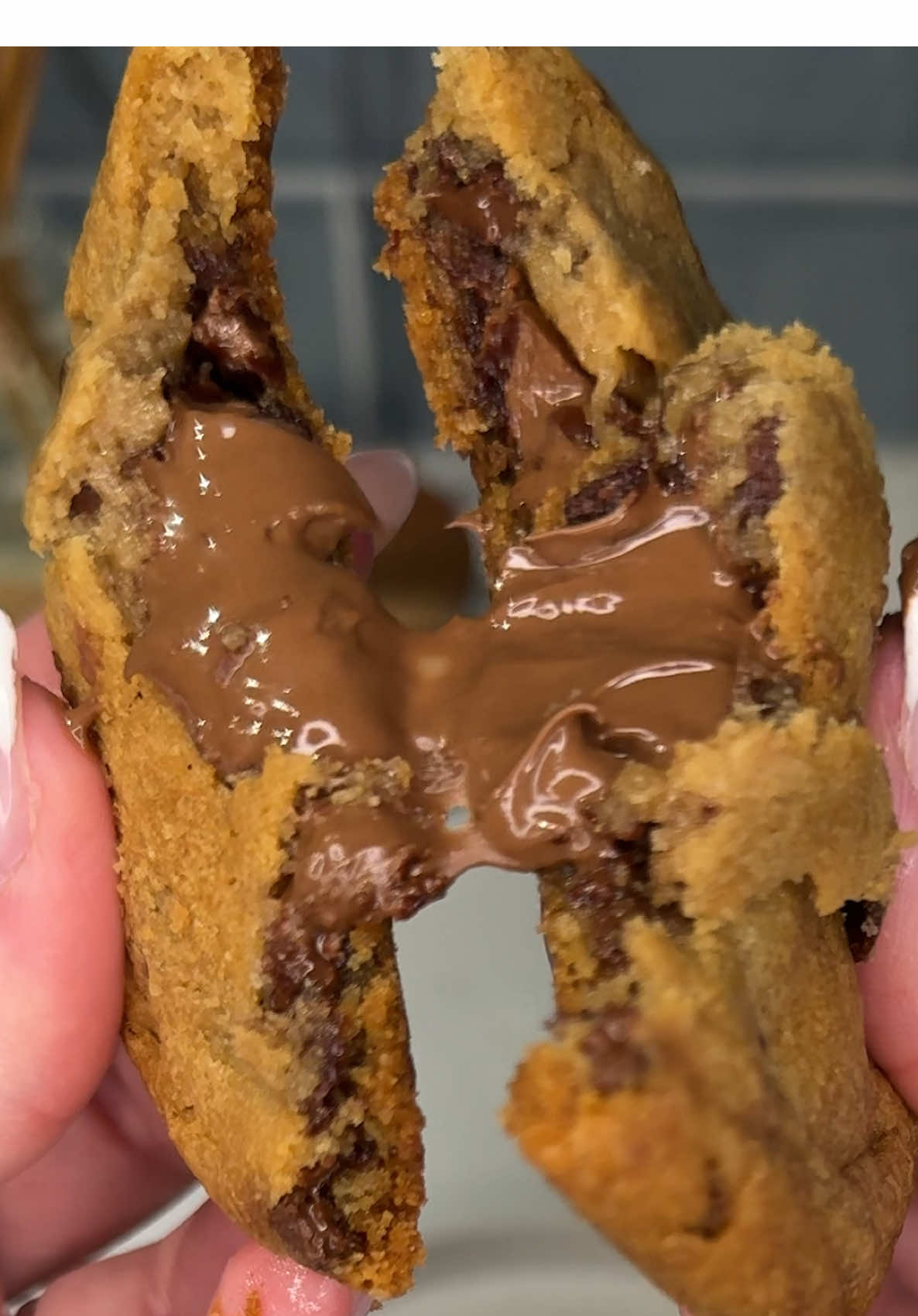the viral Nutella stuffed chocolate chip cookies are sooo satisfying before bed 🍪🍫🤤 Ingredients: 4 dollops Nutella hazelnut spread 4 slices @Pillsbury chocolate chip cookie dough Instructions: On a parchment lined baking sheet, place 4 dollops of Nutella spread and freeze for 30-60 minutes or until firm. Press slices of cookie dough flat and place 1 frozen Nutella dollop in the center of each slice. Form the dough around the Nutella to cover each dollop completely and bake cookies on a parchment lined baking sheet at 350° for 16-17 minutes. Allow to cool for 5 minutes and enjoy! 😋#easydessert #viralrecipe #EasyRecipes #asmrfood #nutella #creatorsearchinsights 