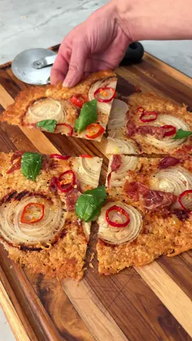 My spin on the low-carb onion chip trend....HOT HONEY & PROSCIUTTO “PIZZA”! Thank you @STELLA DRIVAS for inspiring this awesome trend! Ingredients: 1 small onion sliced thin 1 cup grated Parmigiano Reggiano 2 slices prosciutto cut in half 1 fresno sliced think 4 basil leaves 1 tbsp hot honey Preheat the oven to 400F -Line a large baking sheet with parchment paper -Add the grated parm and form into a circle as shown.  Top with onion slices, prosciutto pieces, and Fresno. -Bake in the oven for 20 minutes or until the cheese is a deep golden brown.  -Let cool for 5 minutes -Top with hot honey and basil, slice and enjoy! #lowcarb #lowcarbsnack #onionchips #viralreels #viralfoodtrend #foodtrend