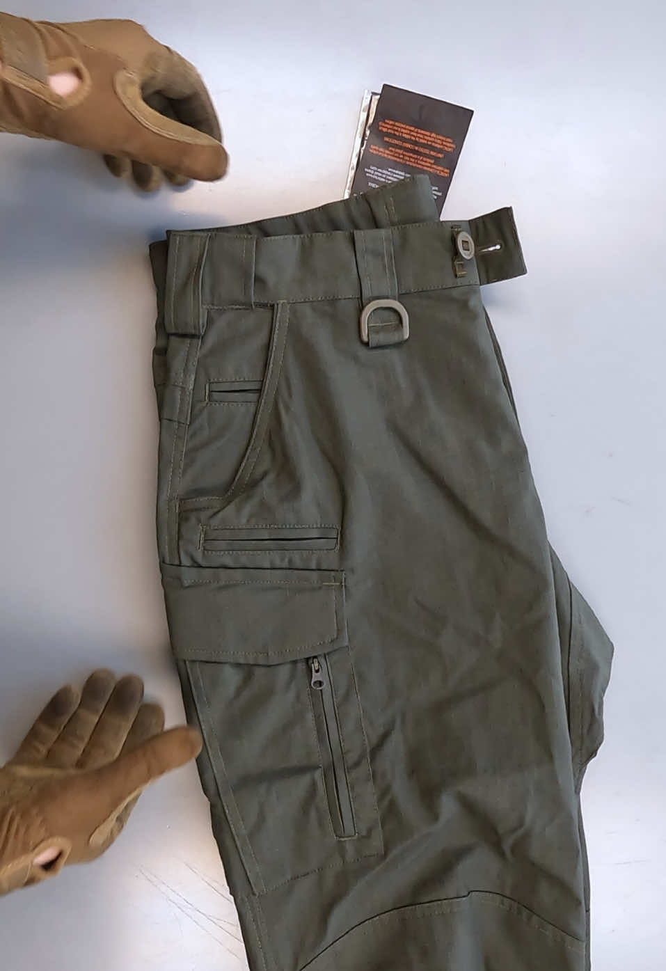 Tactical Pants Lite UATAC The Lite UATAC tactical pants are designed specifically for the military, have a versatile cut and are suitable for a variety of conditions of use - training, shooting range, work or walking. The fabric consists of 65% cotton and 35% polyester, which makes it pleasant to the touch and resistant to tearing and damage. Ripstop weaving will prevent the pants from tearing even under heavy loads. Large cargo pockets with Velcro.Equipped with an additional compartment for storing oversized items and a carabiner. On the side of the cargo pocket there is a zipper for convenient access while sitting. Special convenient phone pocket on the right side. Two front pockets for a knife or flashlight. Large compartment in the knee area with the possibility of installing a knee pad inside (sold separately). The belt is made elastic, with the possibility of stretching. Pants are designed to be worn with a belt up to 6 cm.Convenient Velcro fasteners on the cuffs of the pants. Fabric 65% cotton, 35% polyester. Ripstop weaving Elastic 