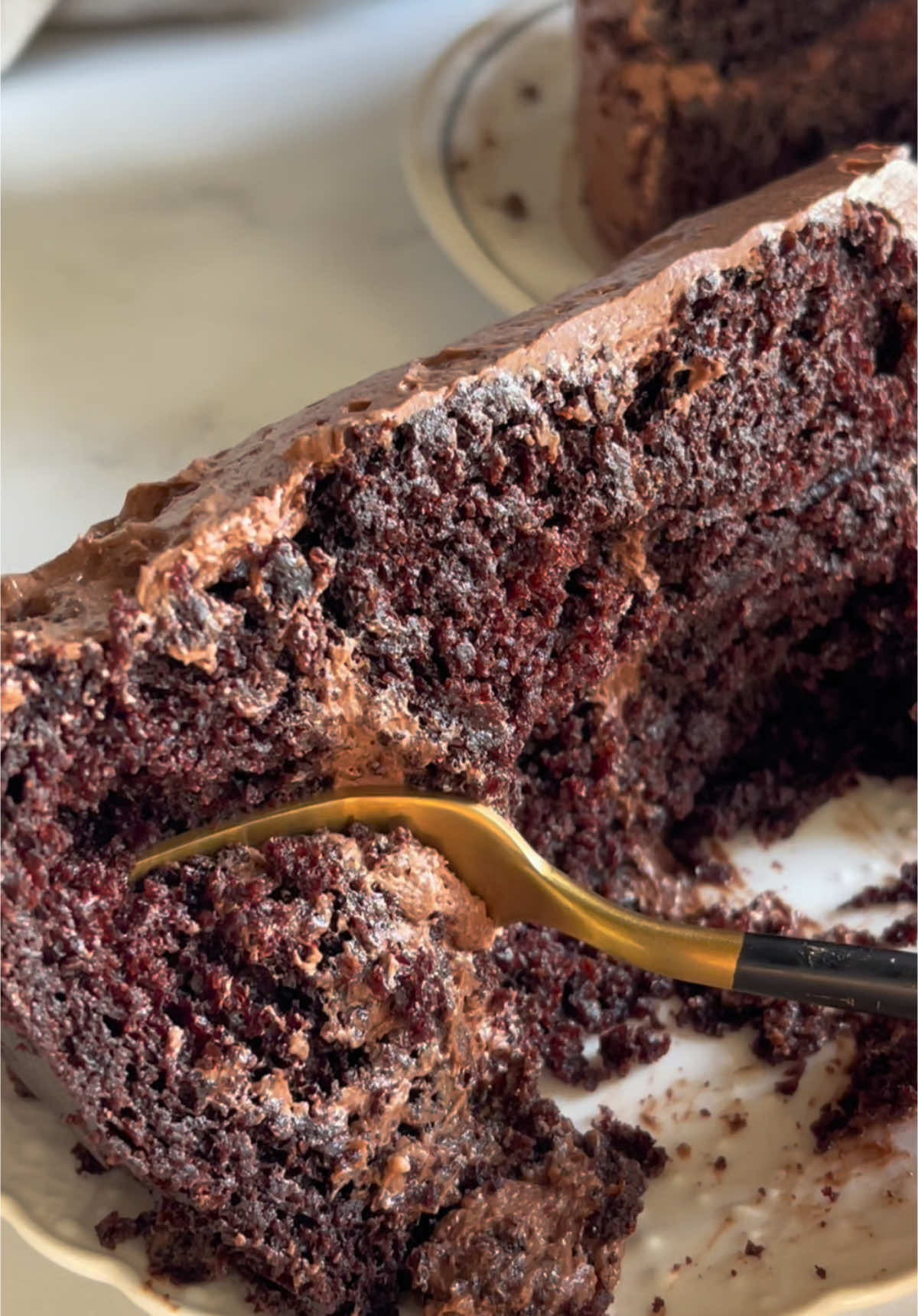 Ingredients - 150 grams gluten-free flour - 100 grams almond flour - 75 grams cocoa - 1 tablespoon baking power - 1 tablespoon baking soda - 1/2 teaspoon salt - 325 grams sugar - 2 eggs - 1/2 cup oil ( coconut or olive )  - 1/2 cup yogurt - 1/2 cup milk or whipping cream - 1 teaspoon vanilla extract - 1 cup coffee or hot water Steps 1. In a bowl, place the eggs, vanilla, sugar, yogurt, milk, and oil and beat very well. 2. In a separate bowl, add the flours, cocoa, baking power, baking soda, and salt and beat very well. 3. Add your dry ingredients to the wet ingredients and beat. 4. Once they are well incorporated, add your cup of hot water little by little and mix. 5. Grease your three small cake pans and divide the batter into three. 6. Preheat the oven to 350°F and bake for 40-50 minutes (or test with a wooden pick that the cake is completely covered). 7. Let cool before adding the frosting. Frosting - 1 stick of butter - 7 tablespoons of whipping cream - vanilla extract - 1 1/2 cups of powdered sugar - 6 tablespoons of cocoa powder Steps 1. Beat the butter until it has a creamy texture. 2. Add the whipping cream and vanilla. 3. Once it's well combined, add the powdered sugar and cocoa powder. #chocolatecake #EasyRecipe #bakingtiktok #glutenfree #creatorsearchinsights #CapCut 