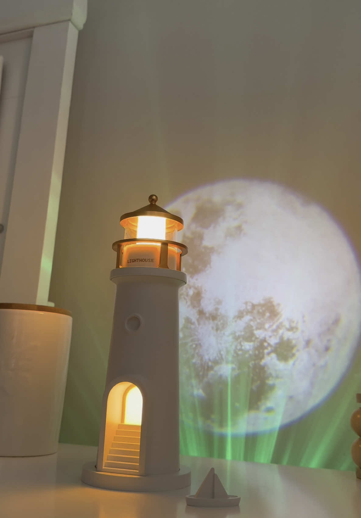 It's a lighthouse-shaped lamp that projects the moon and has a speaker to listen relaxing music 🌕✨ #moon #stars #moonprojector #lighthouse