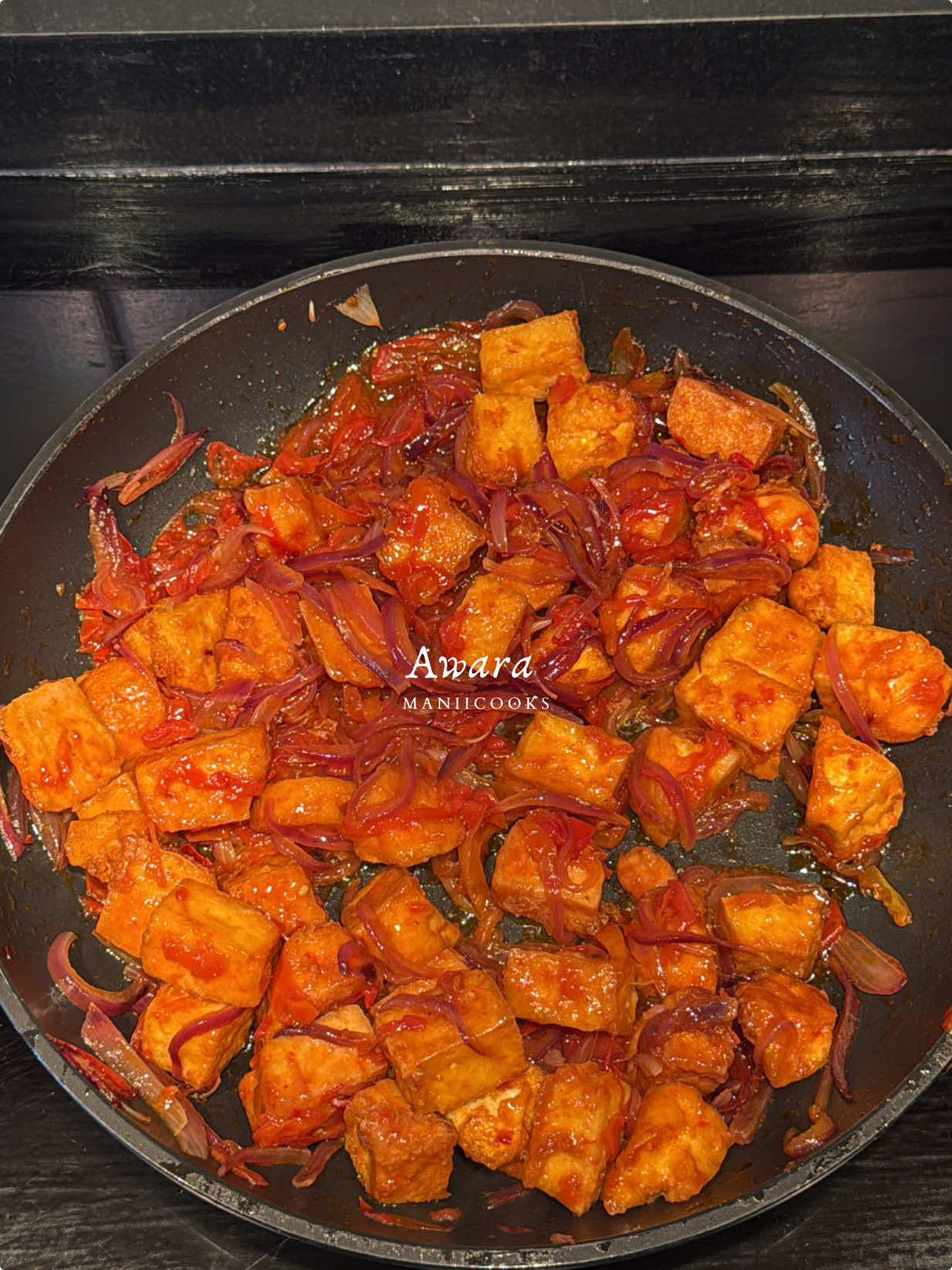 Awara (Tofu) This one’s for my Northerners and anyone who loves a good crunchy snack with a soft center. Awara is made from soybeans and usually fried till golden, then tossed in a simple spicy sauce. Making it at home is actually super doable and way more fun than I expected (not fun at all, i was very clumsy today) Ingredients Soybeans 3 cups Water White vinegar 2 cups  Fresh tomatoes Onions Salt Maggi Yaji Ramen sauce Oil for frying Instructions Soak the soybeans overnight Rinse them once more in the morning Blend with fresh water until smooth Strain the mixture through a cheesecloth to extract the soy milk Repeat the straining process to get the most milk out Discard the leftover chaff Bring the soy milk to a boil and skim off the foam Once boiling, add vinegar and let the mixture curdle Remove from heat and strain again using a clean cheesecloth Let it cool slightly, then squeeze out all the excess liquid Place something heavy on top to press it for about 2 hours Once firm, remove and cut into cubes or triangles Fry in hot oil until golden and crisp Sauté onions and tomatoes in a pan Season with salt, Maggi, yaji, and Robinson’s sauce Add the fried awara into the sauce and mix Serve hot or enjoy dry with sauce on the side . . . . #explorepage #fyp #foryou #reels #arewa #hausa #streetfood