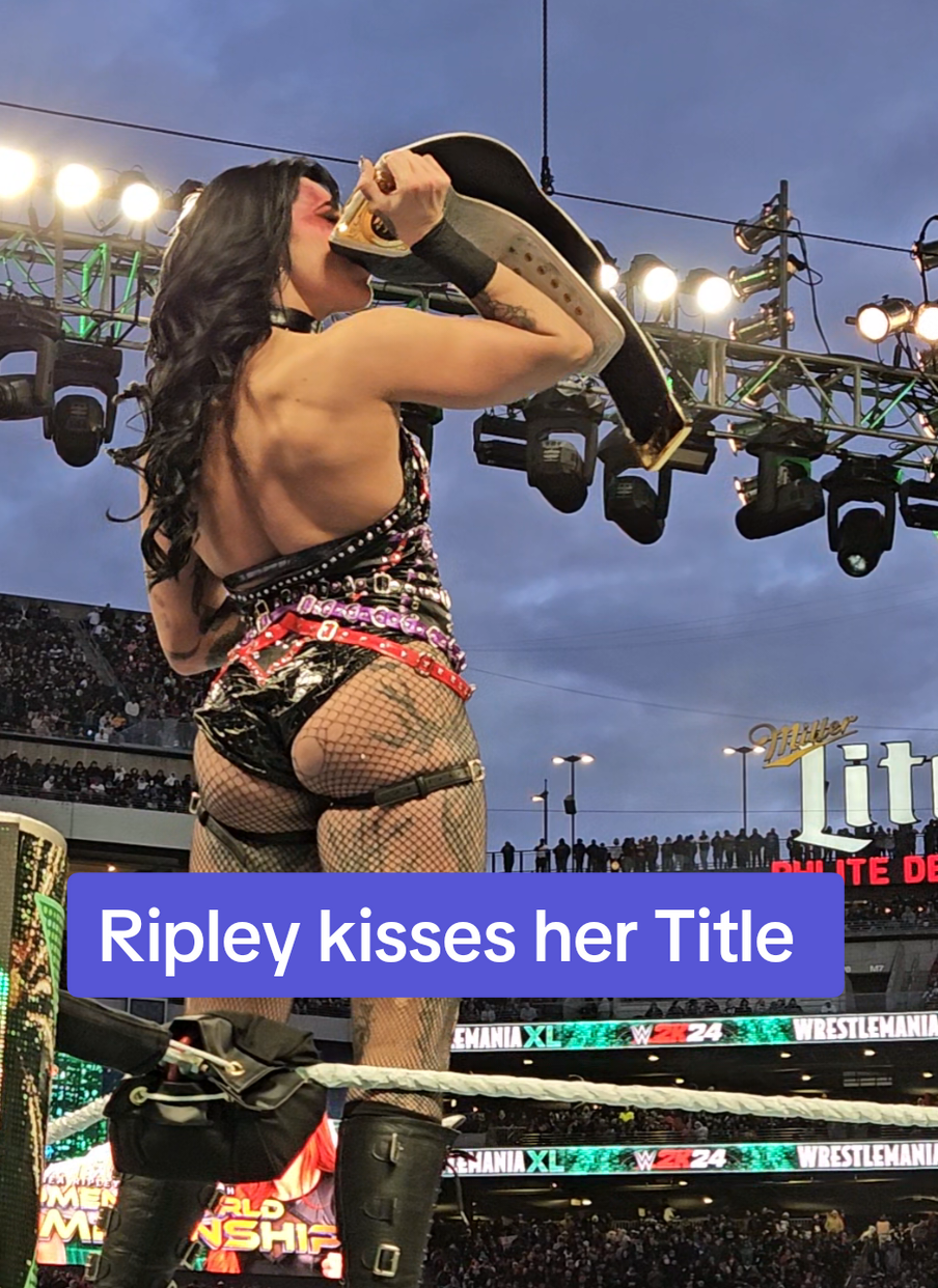 Rhea Ripley kisses the title after her win, while The Man Becky Lynch sits in disbelief. #beckylynch #rhearipleywwe #wwetitle #wrestlemania40 