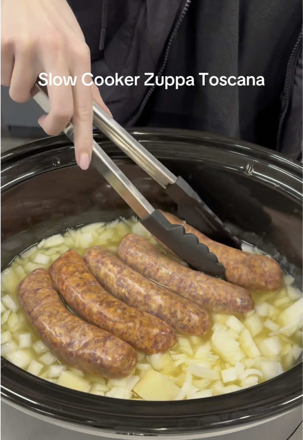 Zuppa Toscana soup made easy in the slow cooker with sausage, potatoes, and kale. We make ours with whole sausages for a meaty bite. Find the full recipe at LINK IN BIO 🔗  #Foodie #cooking #soup #slowcooker #crockpotrecipes #crockpot #easydinner #easydinnerideas #dinner #DinnerIdeas 