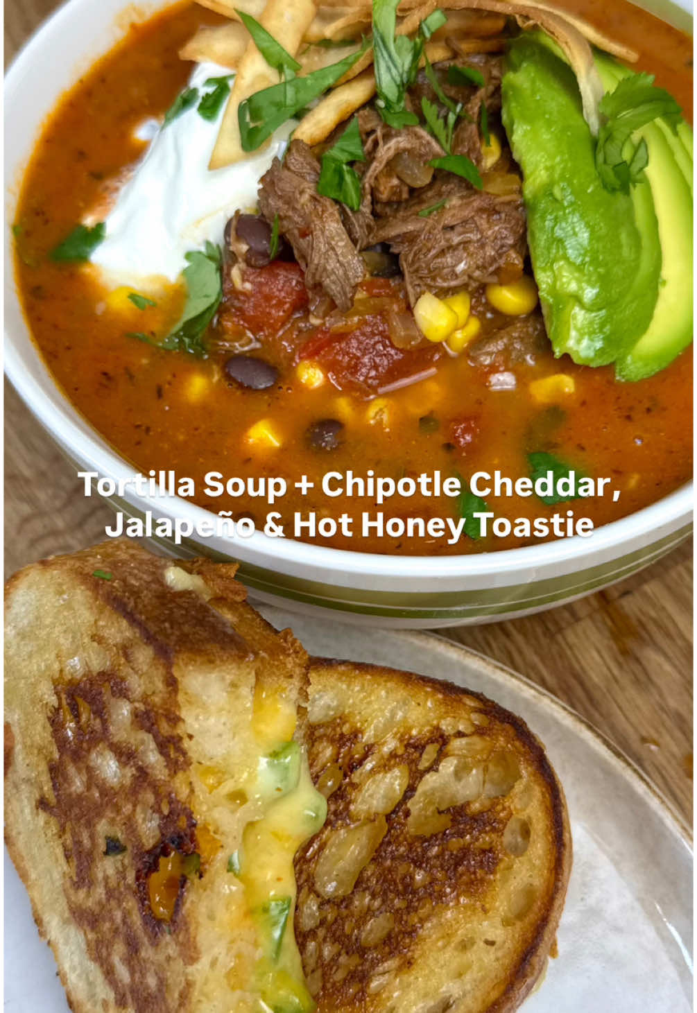 TORTILLA SOUP + CHIPOTLE CHEDDAR, JALAPEÑO & HOT HONEY TOASTIE 🥫🧀🌮🌶️ I genuinely think I’m going to have to put this recipe in book 2…. Wowowowow 11.9/10  Ingredients (serves 4)  See previous video for chipotle beef recipe  1 tbsp olive oil 1 brown onion, finely diced (I used half a red also because I had it in the fridge but not necessary)  1 jalapeño, finely diced, with seeds (you want a mild kick, trust)  2 tsp dried cumin  1 tsp paprika  1 tsp garlic powder  1 tsp onion powder  1 tsp dried oregano  Handful fresh coriander  Salt and pepper  4-5 garlic cloves, finely chopped  400ml tinned chopped tomatoes  1 beef stock pot (any flavour will work)  2 cups water  1 lime, juiced  1/2 tbsp Tabasco (I like the green one)  100mls light cream (optional, not necessary) 420g corn kernels (rinsed)  420g black beans (rinsed)  Cut white corn tortillas into strips and shallow fry in olive oil and season with salt.  Toastie:  Chipotle cheddar (literally the cheese mix from Woolies)  Fresh jalapeño, diced, deseeded  Hot honey  Serve with:  Fresh avocado  Greek yogurt (or sour cream)  Fresh like  And those crispy fried tortilla strips  If you want chipotle protein that isn’t slow cooked, you can use the same marinade that was used for the beef (see previous video). Marinade for minimum 1 hour and cook off in a pan or even air fry it tbh. The measurements for the marinade would easily do 1kg worth of protein.  #mexicansoup #tortillasoup #texmex #soupseason #DinnerIdeas #toastie #texmexfood #EasyRecipes #shreddedbeef 