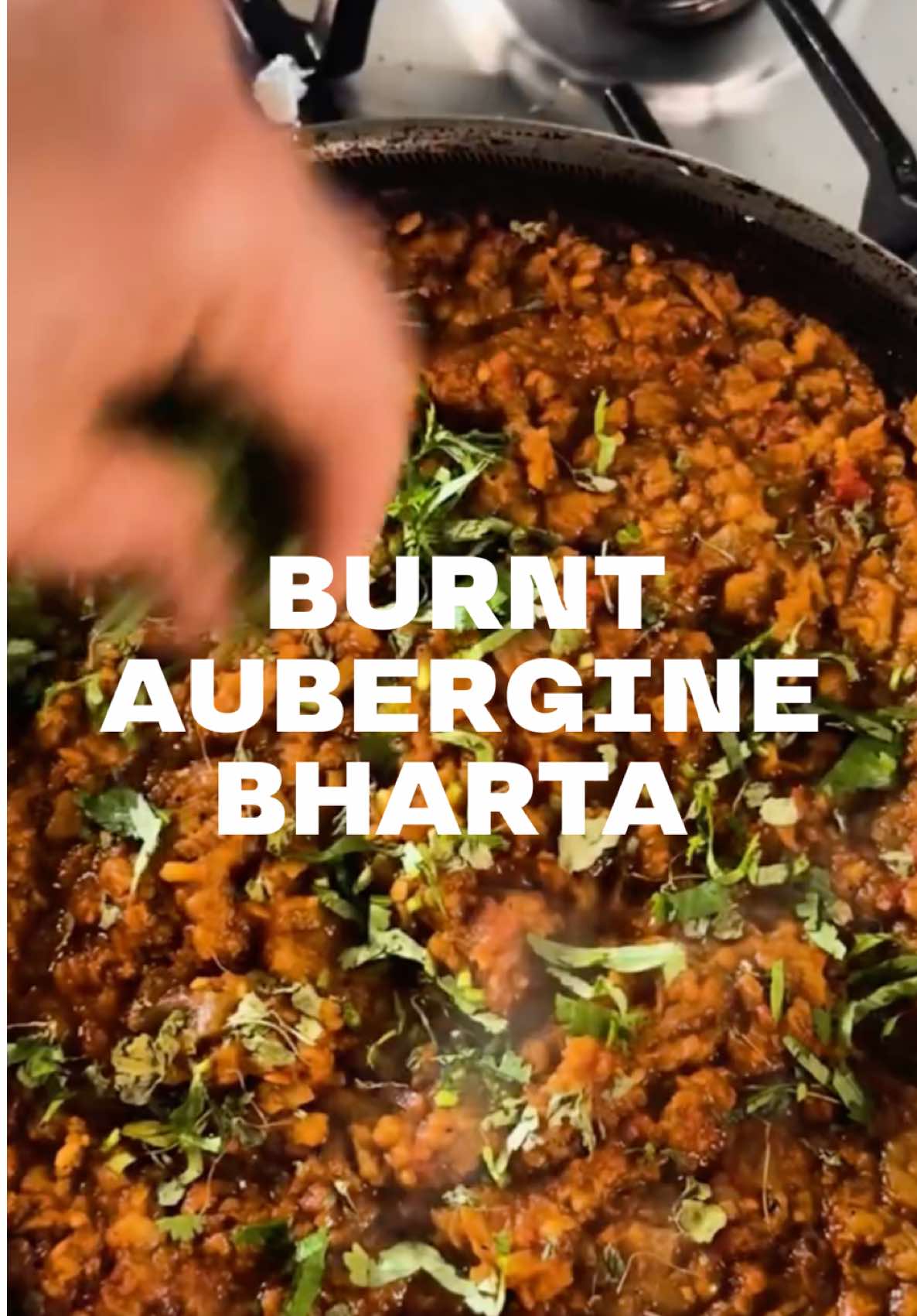 INDIAN 101: BAINGAN KA BHARTA 🔥🌶️🍆🇮🇳 This gorgeous vegan dish needs some effort to get right, but I promise you, every bit of it will be worth it when you finally eat the finished, smoky dish. Like many other dishes from India, there are various versions of it. I love cooking Bharta with mustard oil, but swap for a neutral oil if you prefer. Burning the aubergine is crucial to getting the smoky flavour. You can do this on a gas hob (as I have), a barbeque or right under the grill in a domestic oven. 2 large aubergines 2 tbsp mustard oil 1 tsp cumin seeds 1 medium onion, chopped 1 tsp each, ginger and garlic, minced 1 tsp cumin powder 1 tsp Kashmiri chilli powder 1/2 turmeric 1/2 tsp garam masala 3 ripe tomatoes (or 1/3 tin chopped tomatoes) Large pinch of kasoori methi Fresh coriander and green chilies, to garnish 1. Prick the augergine and rub some mustard oil over it. Then roast over a direct flame until completely charred and softened. Once slightly cooled, peel the skin off with the help of kitchen paper or gloves. Then chop up. 2. Heat the remaining mustard oil in a pan and sizzle the cumin seeds. Then add the onions, some salt, ginger and garlic. Once it all softens add the ground spices and cook for a minute, followed by the tomatoes. 3. After about 5 minutes, add the chopped aubergine and mash everything together, simmering for 6-8 minutes. 4. Garnish with fresh coriander and green chilies and serve with rotis or as part of a larger spread. Enjoy! #indian101 #indianfood #indianrecipes #food #Recipe #aubergine #vegan #bharta #baingan #instafood #curry #cooking 