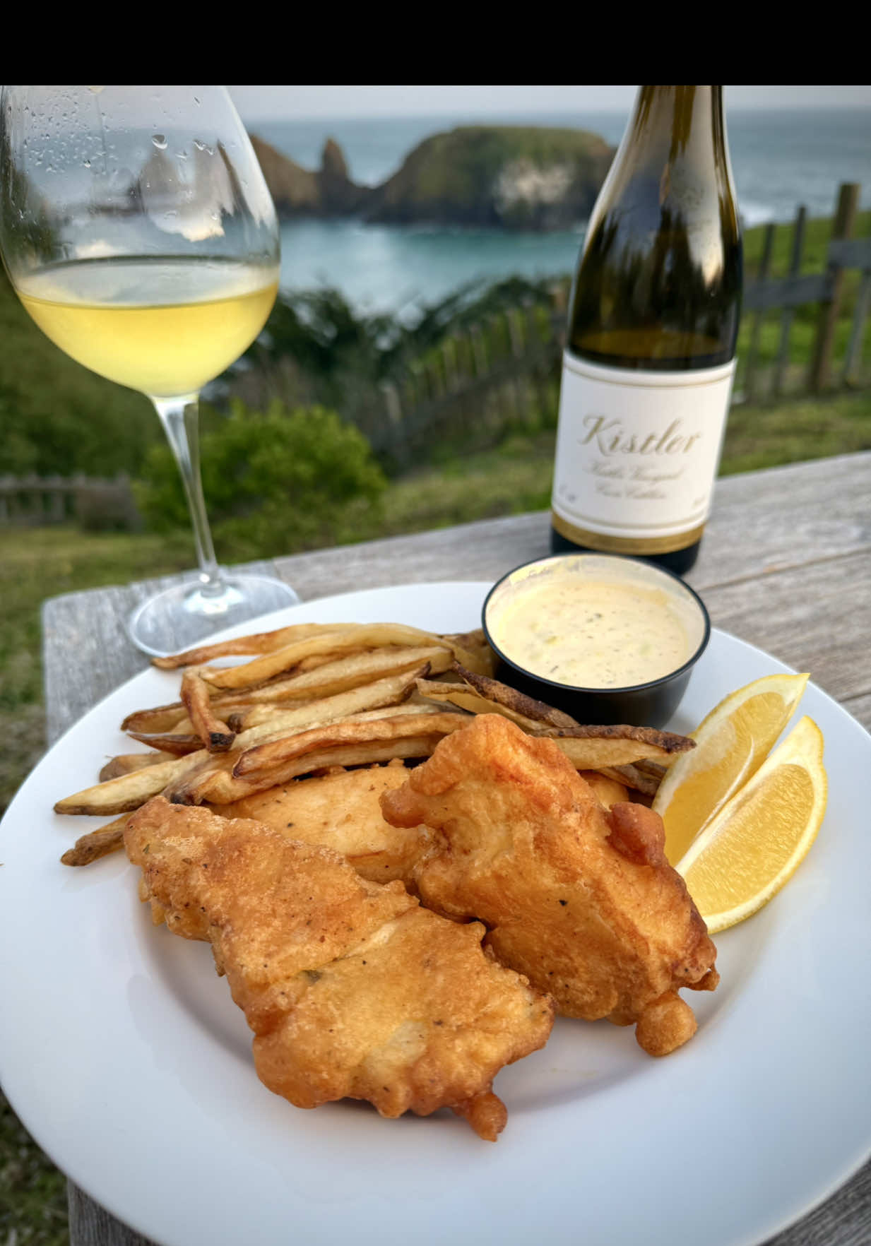North Coast Beer-Battered Fish & Chips with Homemade Tartar Sauce Ingredients Fish & Chips: * 3 cups canola oil * 1 North Coast Scrimshaw Pilsner * 1½ cups all-purpose flour * 1 tbsp cornstarch * 1 tsp baking powder * ¼ tsp baking soda * 1½ lbs halibut or cod, cut into filets * 2 tsp hot sauce * 1 tbsp all-purpose rub * ½ tsp chipotle garlic rub (or sub: ½ tsp salt, ¼ tsp pepper, 1 tsp garlic powder, 1 tsp paprika, ½ tsp chipotle powder) * 4 large russet potatoes, cut into fries * Lemon wedges, for serving Tartar Sauce: * 1 cup mayo * 1 tbsp yellow mustard * 1 tbsp sweet pickle relish * 1 tsp hot sauce * 2 tbsp lemon juice * ½ tsp each: dill, garlic powder, onion powder * Salt & pepper to taste Instructions 1. Light charcoal and heat canola oil in a cast iron skillet to 360–375°F. 2. Combine all tartar sauce ingredients in a bowl. Chill until ready to serve. 3. Soak fries in ice water for 20–30 min, then pat dry. Fry until golden brown. Keep warm in a 225°F oven or double-fry for extra crisp. 4. Pat fish dry and season with rub. In a bowl, whisk flour, cornstarch, baking powder, baking soda, hot sauce, seasoning, and beer to form a batter. 5. Dip filets into batter and fry 4–5 min, flipping halfway, until golden and crispy. 6. Serve hot with tartar sauce, lemon wedges, and a cold Scrimshaw or crisp Chardonnay. #fishnchips #smokenvine #kamadojoe #delicious #teamred #foodporn #reels #fishandchips #friedfish #frenchfries #sogood #mouthwatering #fish #halibut #cod #tartarsauce #homemade #cookingwithfire #getinmybelly #fried #fresh #northcoast #beer #beerbattered #beerbatteredfish #wine #chardonnay #winepairing #foodpairing #northerncalifornia  @Kamado Joe @Bear & Burton's @AMF @Jealous Devil @Derek Wolf @SPICEOLOGY @Lodge Cast Iron @bestfoodsmayonnaise @French’s @Kistler Vineyards @North Coast Brewing Company @Annasea Foods @cangshancutlery @foodandwine @Foodie @Food Network @Gordon Ramsay @Foodies @FOOD 🍟 @Foodporn @@kendrick_bbq 