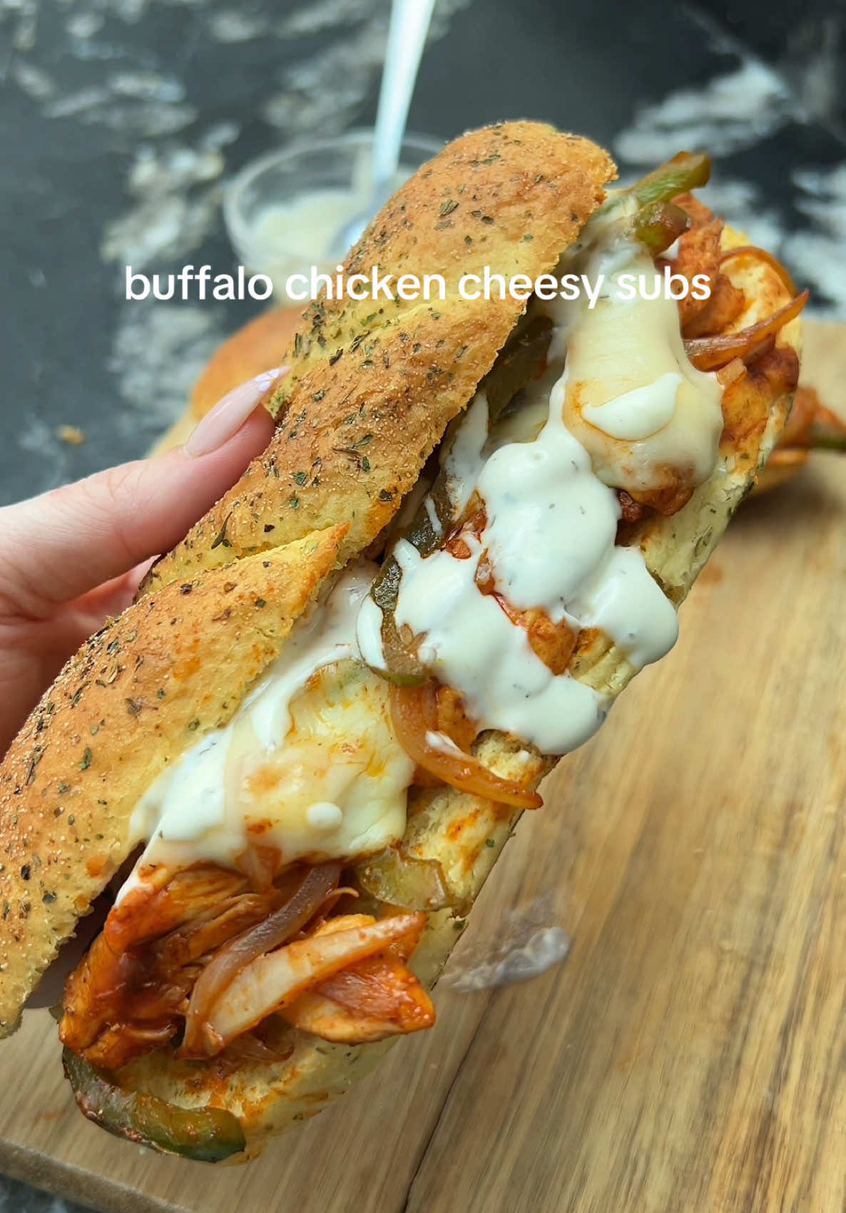 Buffalo Chicken Cheesy Sub 😍  When only something hot, cheesy, and loaded will hit the spot, this sub delivers 😮‍💨 Thinly sliced chicken fried with onions and peppers, tossed in Buffalo sauce, then stacked on a toasted sub roll with melty cheese and a drizzle of ranch 🤭 ‼️ PS: Want more low-cal bangers like this? Grab my cookbook Low-Cal Kitchen Bangers—link in bio! 🫶🏼 Ingredients (serves 2): 200g chicken breast thinly sliced ½ tsp smoked paprika ½ tsp garlic granules 1 green pepper thinly sliced  1 onion thinly sliced 2 sub rolls (I used the cheese and herb ones from tesco) 10g reduced fat butter  40ml buffalo sauce (I use Frank’s)  2 mozzarella cheese slices (can sub for reduced fat cheese)  30g ranch dressing (use less and mix with yoghurt for lower cal/ fat)  💕Start by seasoning the chicken all over with the smoked paprika and garlic granules. 💕Heat a large pan over medium heat. Add the chicken and fry for 4-5 minutes until almost cooked then add the onion and pepper for a further few minutes until the chicken is cooked throughout.  💕Meanwhile, lightly toast the sub rolls under the grill.  💕Add the butter to the pan. Once melted, pour in the sauce and toss to combine. Remove from heat.  💕Top one half of the sub roll with the chicken and veggie mix. You will have to pile it on and pack it down. 💕Slice the mozzarella cheese slices in half and add to the top of the subs.  💕Return to the grill for a minute to allow the cheese to melt. 💕Remove and drizzle over the ranch dressing before serving.  Calories per sub: 538 l Protein: 37.9g l Fat: 23.2g l Carbs: 43.8g  • • ____________ #buffalochicken #dinnerrecipe  #lowcaloriemeals #highprotein #EasyRecipes #quickrecipes 