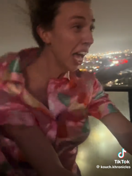 Beautiful woman getting blasted by hurricane force wind in her silk pajamas