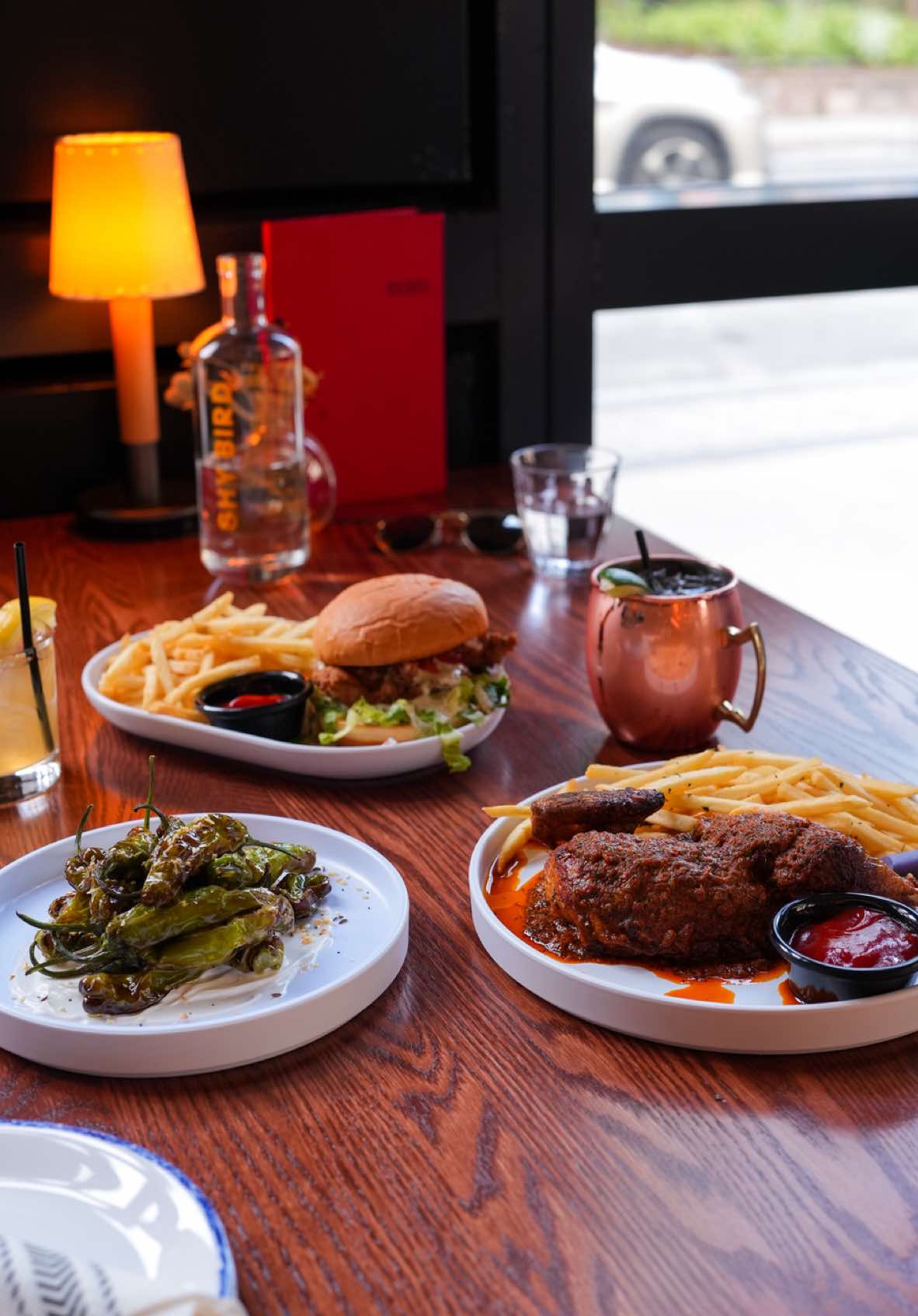 Shy Bird is knocking it out of the park with this menu! The perfect way to kick off a Red Sox night! ⚾️ We started with the blistered shishito pepper: smoky, salty, and addictive. Then came the peri peri chicken, perfectly spiced and juicy, and the fried chicken sandwich, crispy on the outside and tender inside.  📍 Location: 201 Brookline Ave, Boston, MA 02215  🚇 Getting There: Take the MBTA Green Line to Kenmore Station. From there, it’s about a 5-minute walk to Shy Bird.   🏟️ Proximity to Fenway Park: Just a 5-minute walk to the stadium perfect for pre-game dining!  @Shy Bird @The Fenway  #Boston #BostonRestaurants #bostoneats #bostonfood #fenway #fenwayeats #bostoncreator 