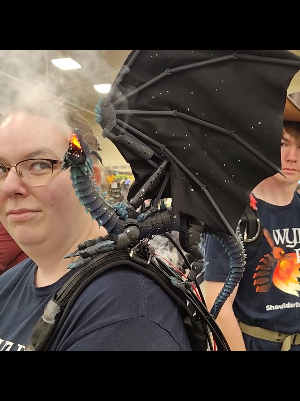 When you bring more then one Shoulder Dragon you have to keep an eye on all of them lol 😂 Watch the Red Dragon in the background 🔥 #cosplay #shoulderdragons #larp #shoulderdragon #comicconvention #dragonpuppet #dragon #comiccon #fantasy #renassaince #shoulderdragonpuppet #larping #wyrmfire #renfaire #comiccon2025 #renaissancefestival #renaissancefaire #LARP #renaissancefair #grandrapidscomiccon 