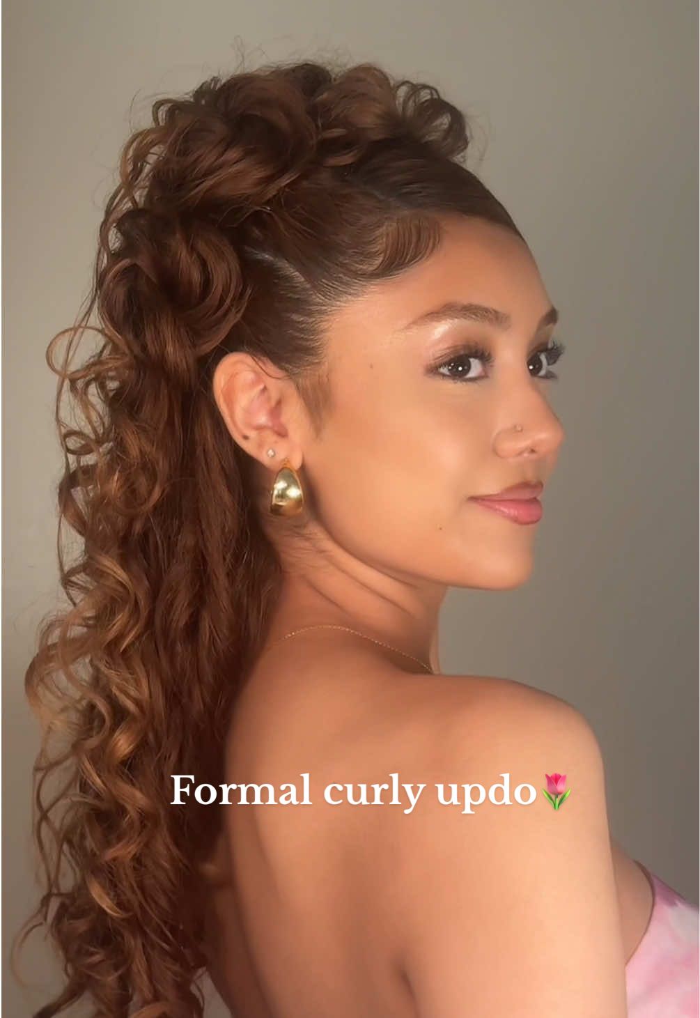 Curls can be formal too ♡︎ i’m so in love with how this turned out 🌷  (Part 3 - prom series) How I achieved this look:  1. Create a side part. Part out the front bang & section off with a clip. 2. Part diagonally on one side of the head. Slick back the roots with gel on the parted section & tie off into a pigtail. 3. Part another diagonal line next to the pigtail you just parted & repeat the process. (you should end up with 5 sectioned pigtails) 4. Take each pigtail (one at a time) and twist it into a mini messy bun-  simply roll the hair in a circle, hold at the desired shape & pin to secure  5. For the outer buns, split the pigtail in half and only twist the top into a bun. Leave the bottom down/slightly pinned at the lower part of the bun for balance/layering. 6. Refresh any frizz from parting with curling cream. 7. Slick back the front bangs & pin to the side. 8. Finish by smoothing baby hairs & any strays!! Products used:  @Rizos Curls stronghold gel, curling cream & wax stick ✨ #promhairstyles #prom2025 #springhairstyles #curlyhairinspo 