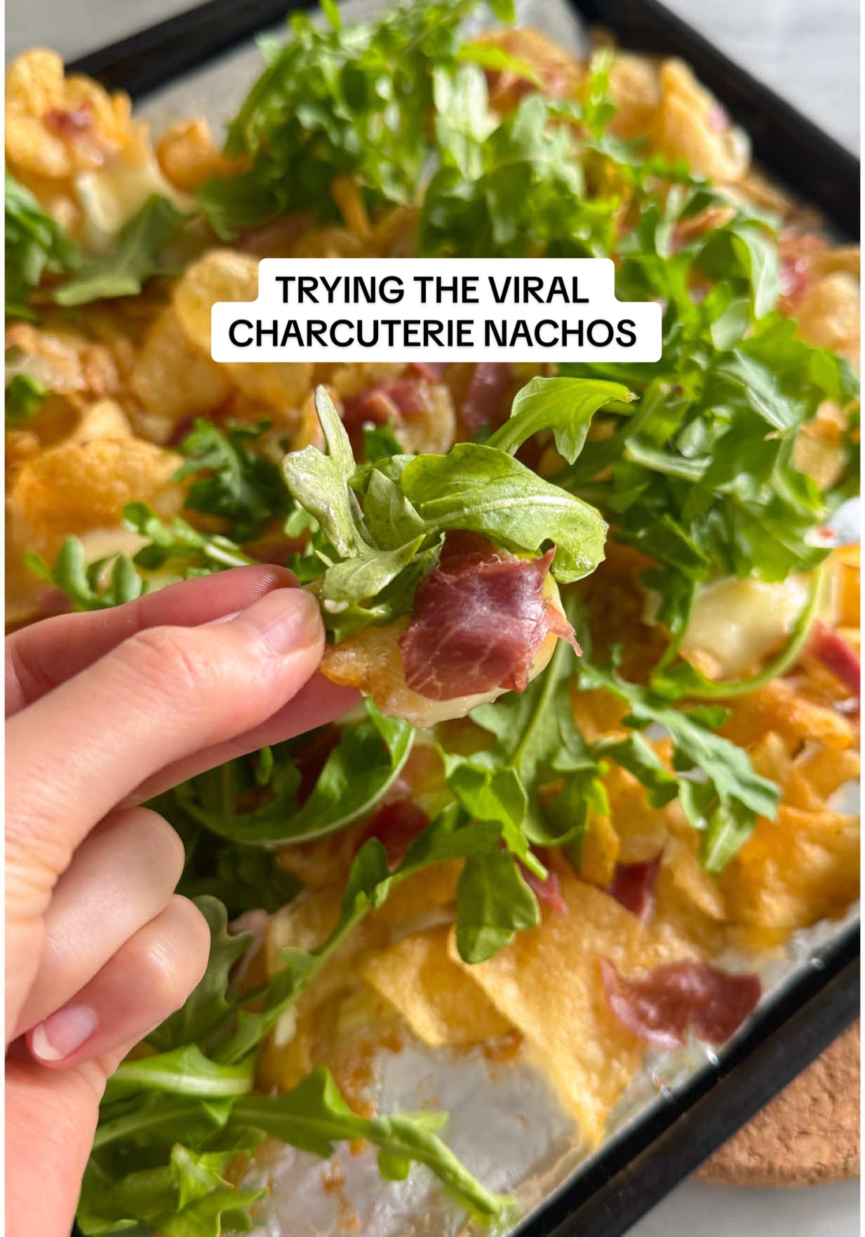 Finally tried the viral charcuterie nachos 😋 Save to try for a girls night in or a fun weeknight snack! You can really put anything you want on them. 🧀CHARCUTERIE NACHOS🧀 - Potato chips (Would pick something less salty next time since it felt too salty with the charcuterie) - Charcuterie meats like prosciutto and salami - Cheese. (We used brie! Make sure to add a lot to make the chips cheesy.) - Toppings like arugula, jam, hot honey We baked in our @Ninja Kitchen toaster oven / air fryer at 350 for about 5 min to get the cheese all melty. 10/10 would make again. We’d just add something sweet for sure to balance the salty! #charcuterienachos #snackideas #EasyRecipes 