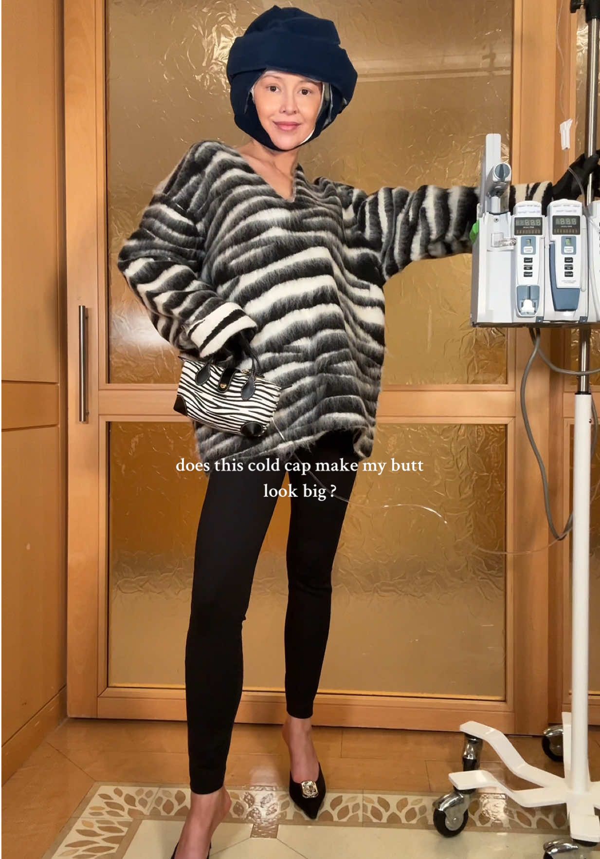 wait for it… not the @Maison Alaïa gloves !!! that I got on clearance because i am still here, still freezing, still hoping, still believing. 💗 we dress up because giving up isn’t on the calendar and because we found this 🦓 @marcjacobs sweater for 80% off in the cold weather clearance. Go off @FWRD #chemo #breastcancer #coldcap #bridgetandmike #fitcheck 