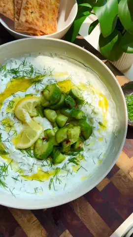 Tzatziki DIP & seasoned pita chips  perfect appetizer or dip and topping !! Tzatziki:  1. 2 cups, plain Greek yogurt, whole milk or non-fat 2. One large English cucumber, grated , skin removed  3. 2 tablespoons chopped fresh dill 4. 4 garlic grated  5. Juice of one lemon  6. 1 teaspoon salt and black pepper 7. 1 tablespoon olive oil  8. 1 teaspoon vinegar- optional  Cucumber relish : mix together  1. 2-3 mini cucumbers cut into quarters  2. Pinch of salt and pepper  3. 1/2 teaspoon or more crushed chili flakes  4. Squeeze of lemon  5. Olive oil enough to mix 1. Remove the skin of your English cucumber and grate cucumber.  2. In a clean kitchen towel add the cucumber twist to remove all of the excess water.  3. In a nice serving bowl add 2 cups of good quality Greek yogurt.  4. Add in the grated cucumber, Chopped dill, garlic, lemon juice, salt, pepper, and vinegar.  5. Mix well.  6. Top with olive oil, cucumber relish, and garnish with dill and lemon slice.  7. Serve with pita chips, seasoned pita chips, crackers or vegetable slices.  #foodies #eat #delicious  #chicken #beef  #appetizer # recipe #recipes #cooking #instafood #igdaily #dinner #food #yum #instagood #foodporn #foodstagram #snack #foodgasm #instadaily #tasty #tastyfood #chickenrecipes #reels #reelsinstagram #reelsofinstagram #reelsviral #reelsinsta #Foodie #deliciousfood chickens lunch bbq salad beef Mexico Chinese food take out fake away eeeeeats huffposttaste bhg  4thofjuly bbq cookout summer party get together  #foodtik #foodtiktok #FoodTok