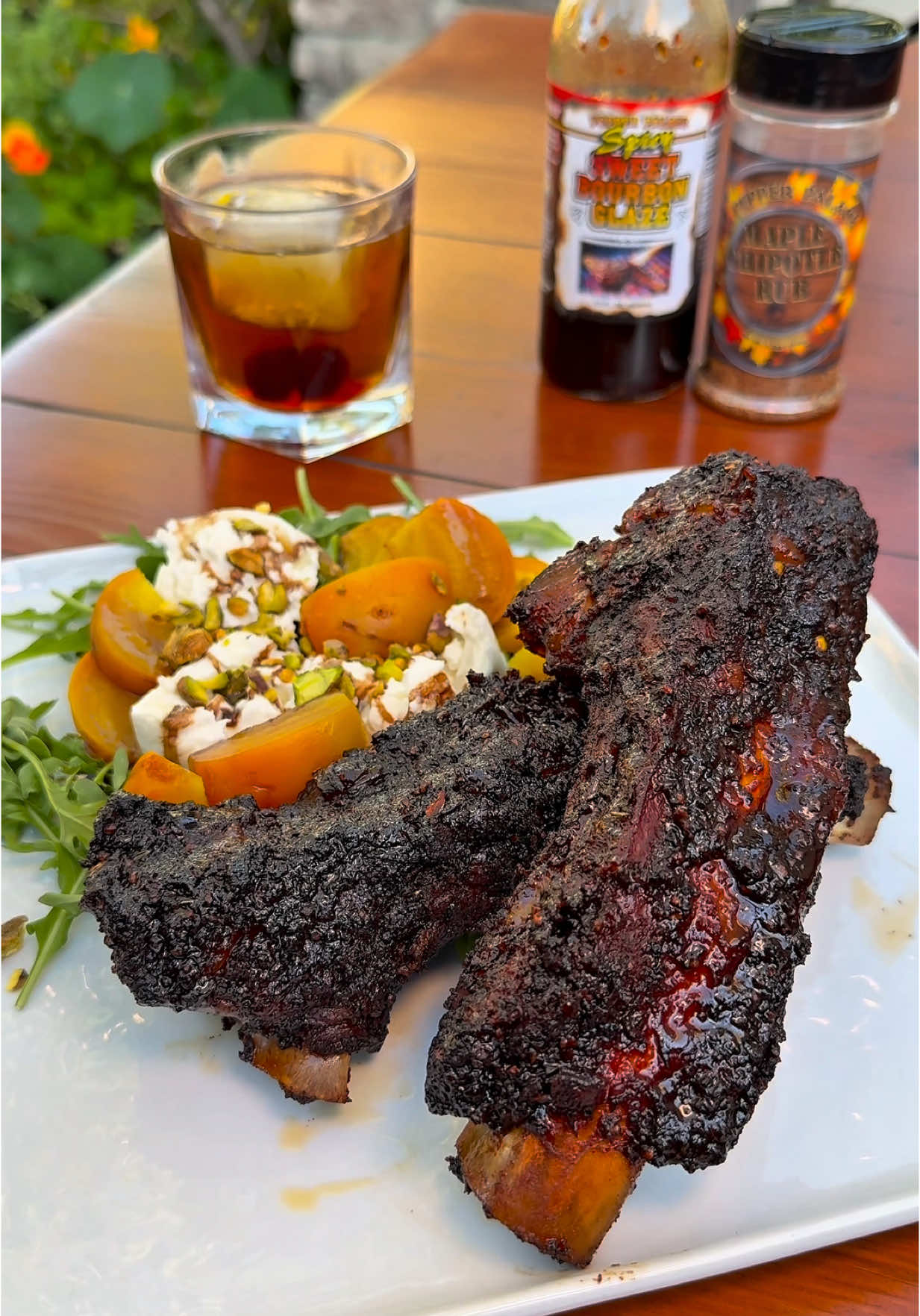 Maple Bourbon Glazed Beef Back Ribs Ingredients: * 1 rack of beef back ribs (whole or cut into singles) * Worcestershire sauce (binder) * Pepper Palace Maple Chipotle Rub * Blazing Star Beef Rub * Pepper Palace Spicy Sweet Bourbon Glaze * Beef broth * Beef tallow Instructions: 1. Prep the Ribs: Use Worcestershire as a binder, then season generously with Pepper Palace Maple Chipotle Rub and Blazing Star Beef Rub for a bold, sweet-heat crust. 2. Smoke Phase: Smoke ribs at 250°F for about 3 hours, or until the internal temp hits 165°F. Let that bark develop. 3. Braised Finish: Place ribs in a pan with a layer of beef broth underneath. Pour a mix of beef broth and tallow over the top. Cover tightly with foil and return to the smoker until probe tender—around 207°F. 4. Glaze & Set: Brush with Pepper Palace Spicy Sweet Bourbon Glaze and return to the smoker for 10–15 minutes to set that sticky, caramelized finish. Serve with: A burrata beet salad and a maple old fashioned for the perfect sweet, creamy, smoky pairing. #beefbackribs #beefribs #maplebourbon #bourbonglazed #beef #smoked #smokedbeefribs #mapleoldfashioned #oldfashioned #yum #dizzle #bbq #bbqbeef #smokedbeefribs #smokedbeef #delicious #kamadojoe #smokenvine #teamred #foodporn #food #bbqlovers #sogood #bbqlife #bbqbeefribs #oldfashion #cocktails #foodpairing  . . @Kamado Joe @blazingstarbbq @Bear & Burton's @Pepper Palace @Jealous Devil @AMF @Costco Wholesale @Costco TikTok @HexClad @Gordon Ramsay @Nordic Ware @foodandwine @Foodies @Food Network @FOOD 🍟 @Foodie @Foodporn 