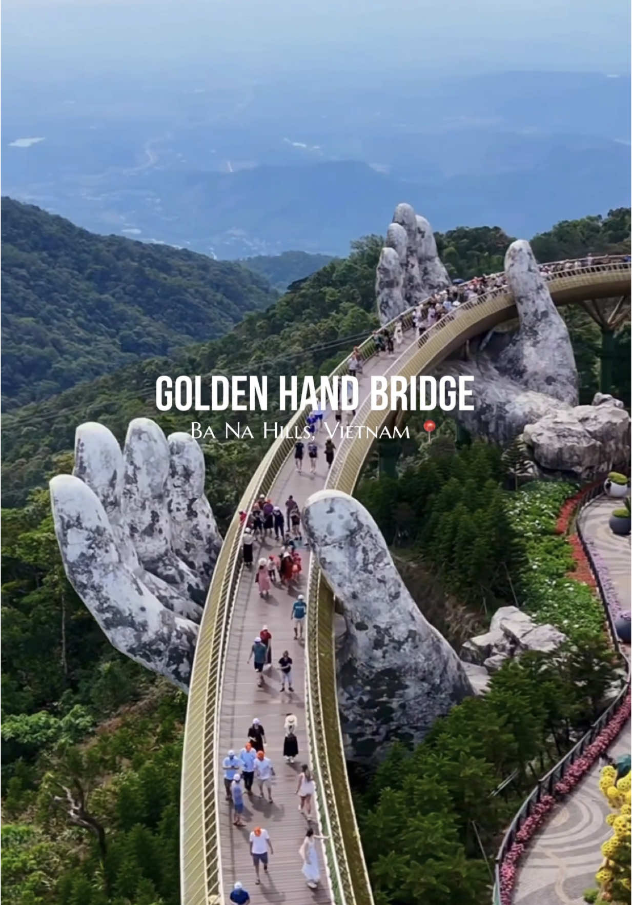 Next place added to your bucket list 📍 This whole destination has blew me away. The Golden Bridge is massive in person, and the whole mountaintop setup is unlike anything I’ve seen. Tips if you’re visiting: 	1.	Be there early—gates open around 7:00 AM. Crowds get heavy fast.  2.	It’s about 1.5 hours from both Hoi An and Da Nang.  	3.	There’s a hotel at the top if you want to stay overnight and catch the bridge at sunrise or sunset without the chaos. 	4.	The French Village is worth a stroll—feels a little like Disney, but fun for food, drinks, and views. Fun fact: The bridge was built to look like the “hands of the gods” holding up a golden thread between the mountains and sky. #vietnam #handbridge #handbridgevietnam #travel #drone #travelphotography #views #danung #banahills #adventure #statue #fyp #foryou #explore #asia #Summer #dji #bridge #bucketlist