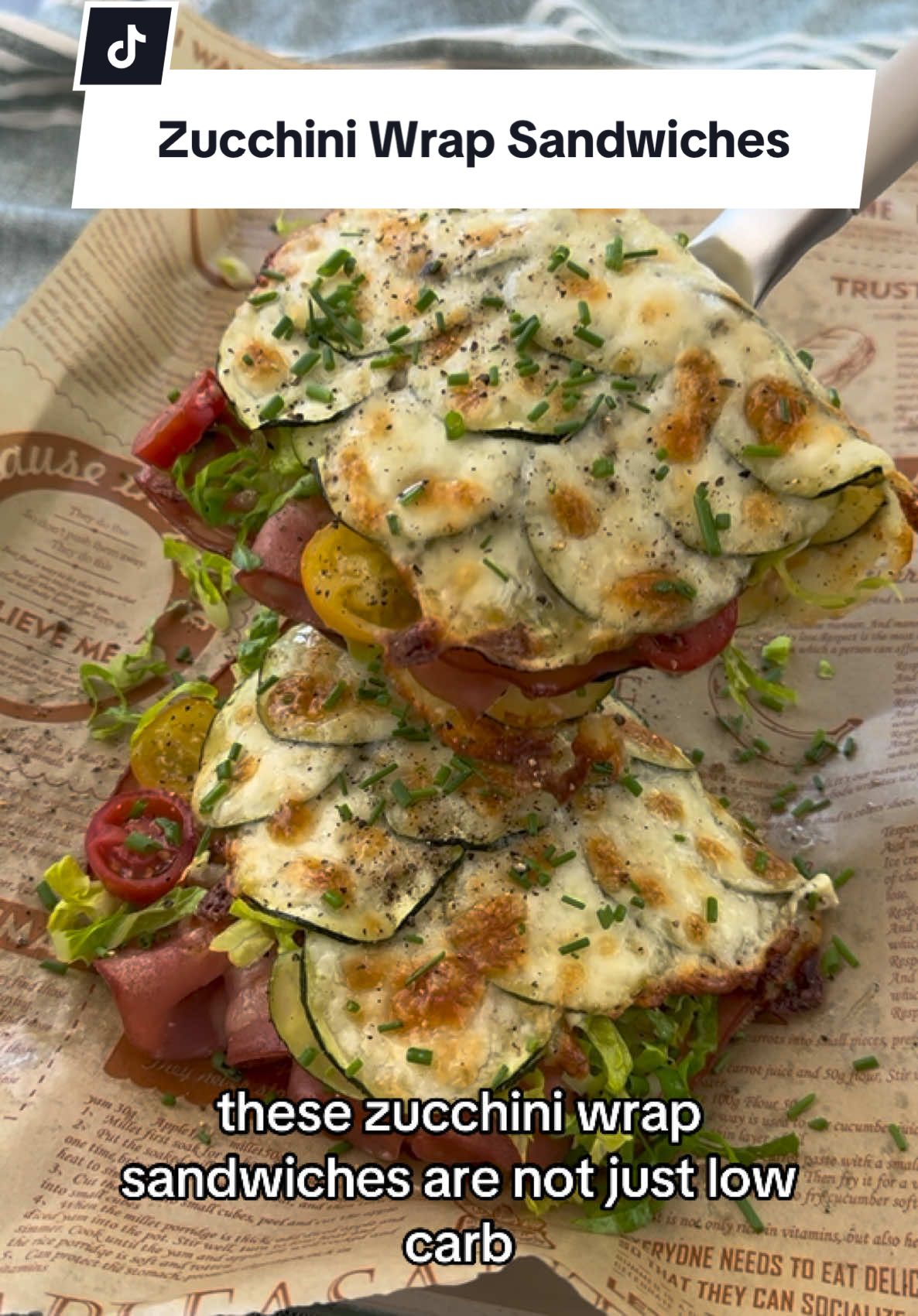 Zucchini Wrap Sandwich- not just low carb but super cheesy and delicious 🤤 Ingredients for 2 sandwiches:  1 zucchini  2 tsp olive oil  1 cup mozzarella  Black pepper  8 slices mortadella  2 slices provolone  Romaine lettuce Tomatoes  Chives  Dijonaise:  1 tbs mayonnaise  1 tsp Dijon mustard  Method:  1. Preheat oven to 350 F; 2. Thinly slice your zucchini and arrange on a greased parchment paper; top with mozzarella and roast for 15 minutes;  3. Broil mortadella and provolone until cheese is bubbly;  4. Cool zucchini wrap for a few minutes and flip; spread dijonaise and place mortadella and cheese on the wrap, followed by lettuce and tomatoes; fold, top with chives and enjoy!  #zucchiniwrap #zucchini #sandwiches #lowcarb #anthonybordain #recipeshare