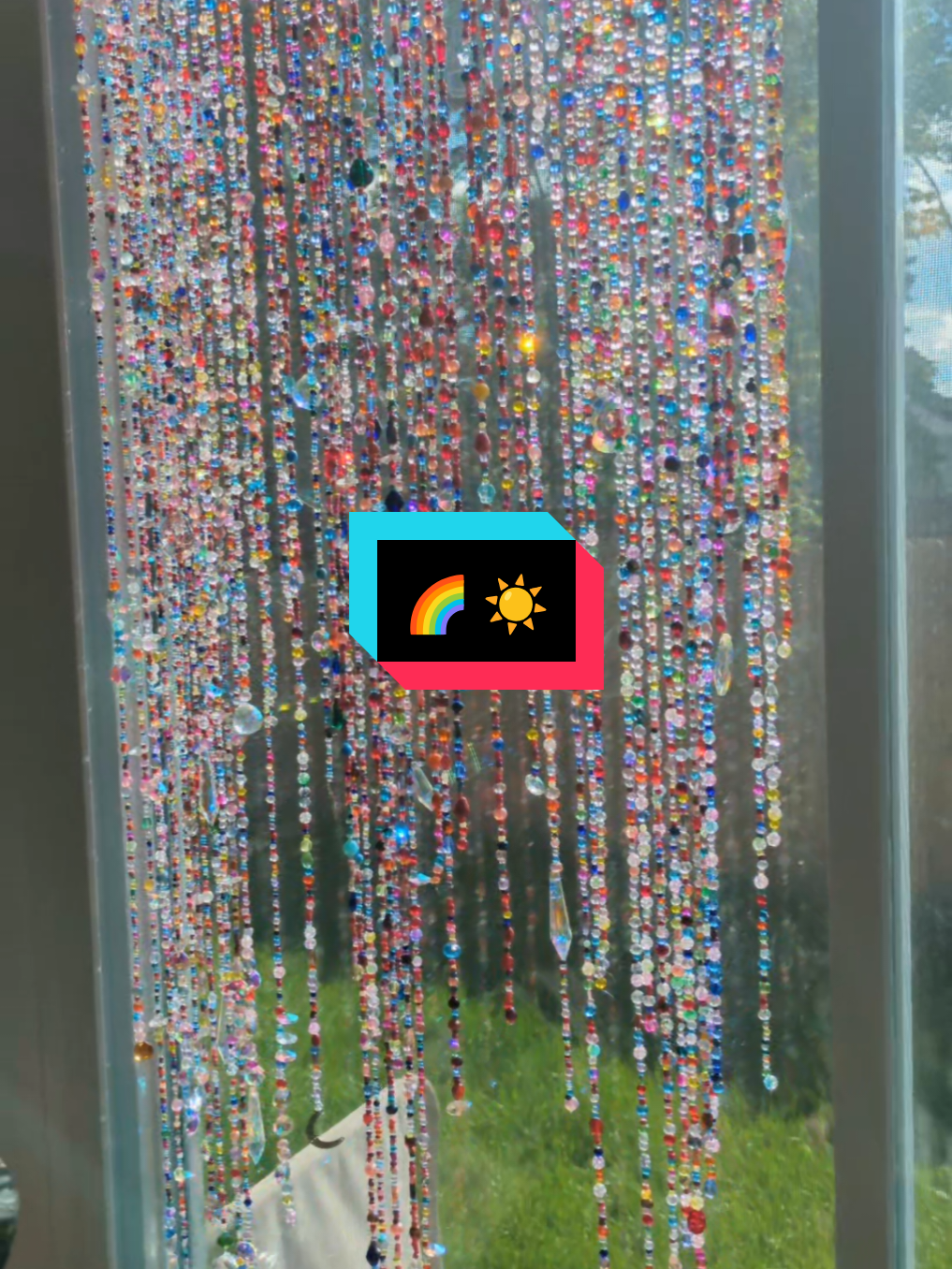 beaded diy curtains in the afternoon sunshine. #diybeadedcurtain #beading #crafts #beadart #crafttok #glassbeads #suncatcher #DIY #beadcrafts 
